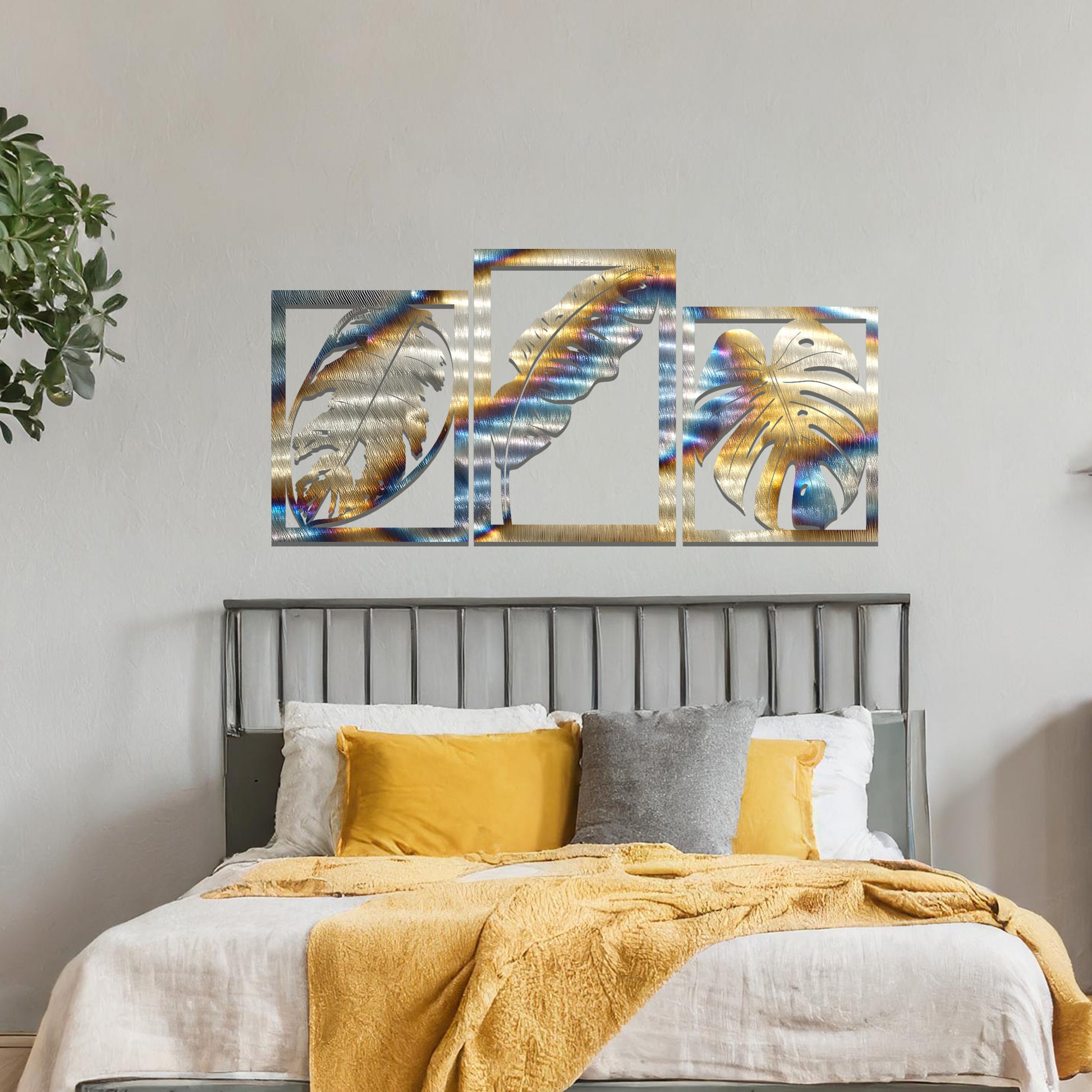 A metal wall art design featuring three leaf patterns, each in its own rectangular frame. The art is displayed on a neutral wall within a modern office space, enhancing the environment with its natural and minimalist appeal.