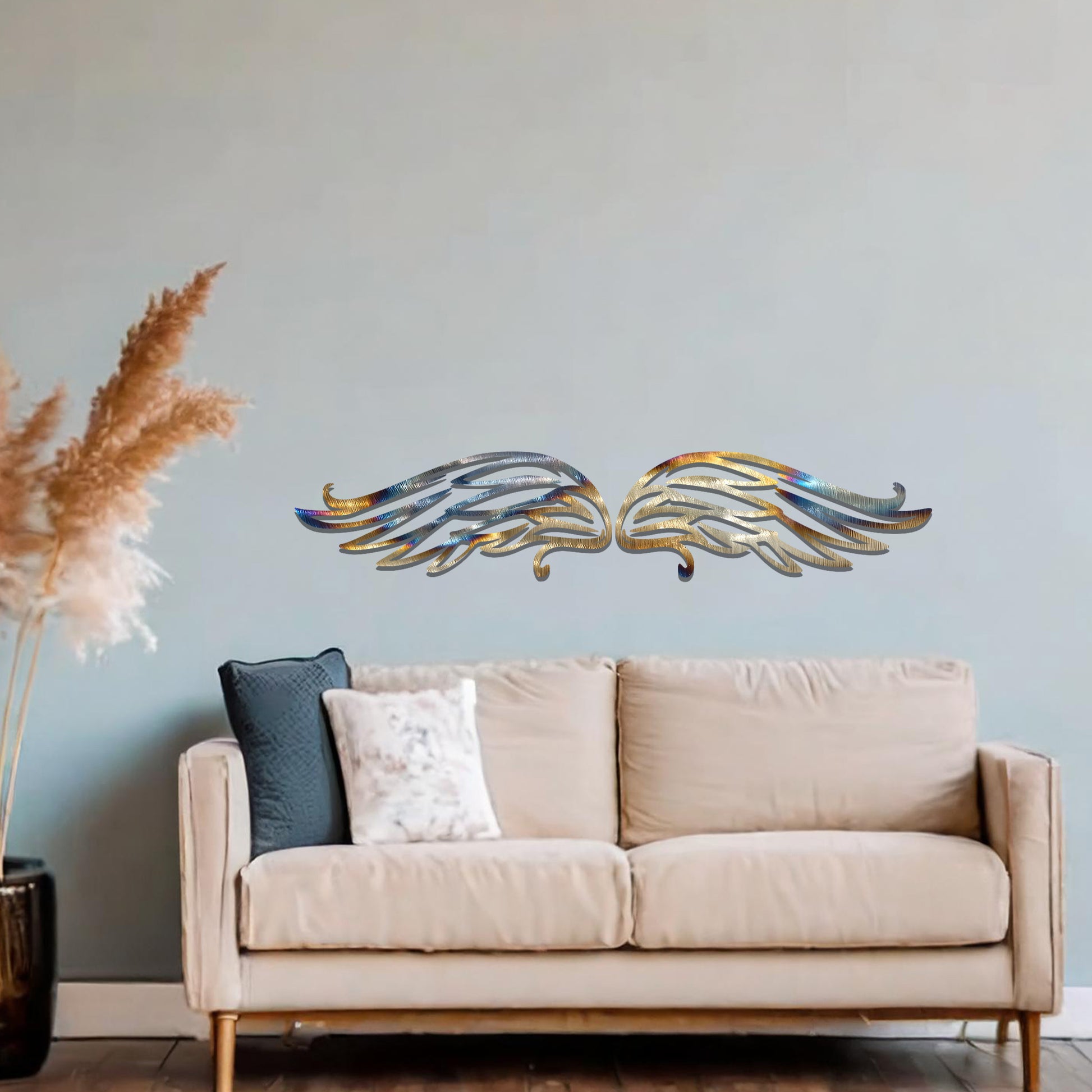 A striking metal wall art design of intricately detailed wings, symmetrically positioned with elegant feather-like lines. The artwork is displayed on a neutral wall within a modern decor setting, adding a touch of sophistication.