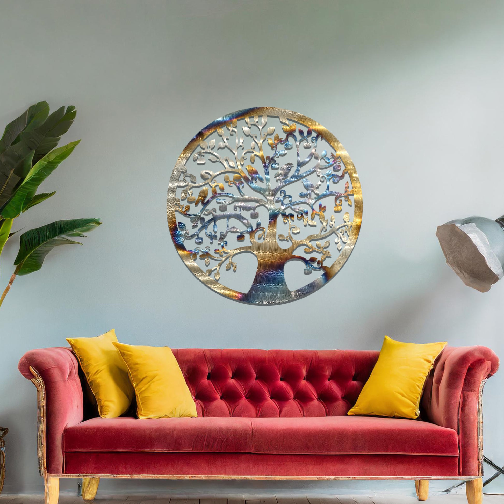 Metal wall art featuring a circular tree design with intricate branches and leaves, showcasing a detailed and balanced composition, displayed on a neutral wall within modern decor.