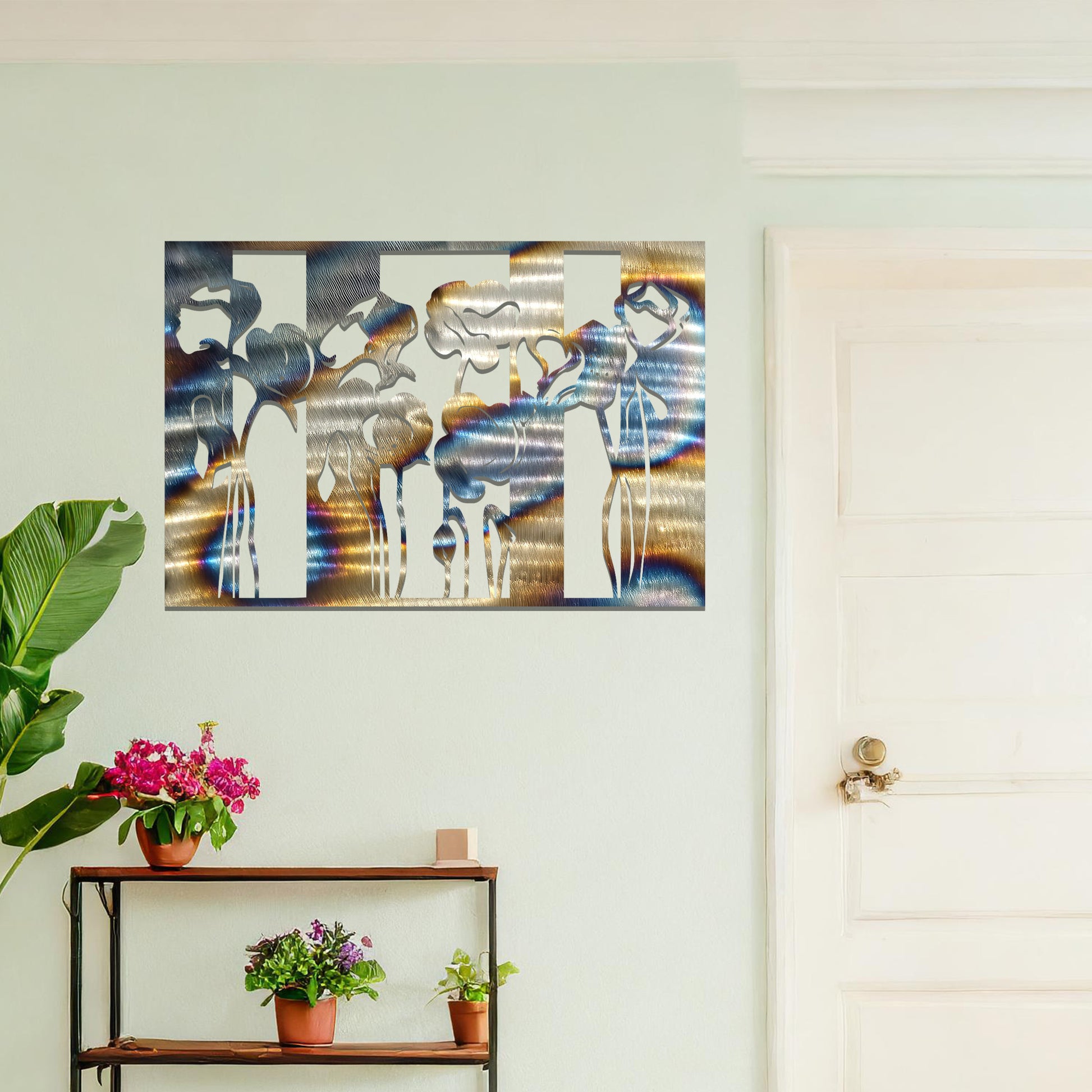 A metal wall art design featuring stylized flowers with long, elegant stems, arranged vertically in a series of three sections. The art is displayed on a neutral wall within a modern room decor, adding a contemporary and artistic touch to the space.