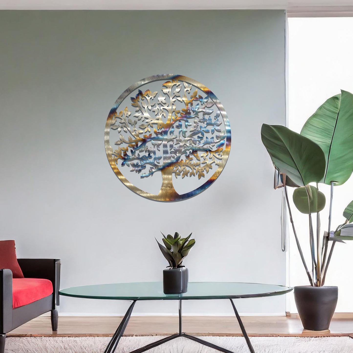 Metal wall art featuring a circular design with a detailed tree of life motif, showcasing intricate branches and leaves, mounted on a neutral wall within modern room decor. The elegant craftsmanship and symbolic design add a touch of sophistication and meaning to the space.