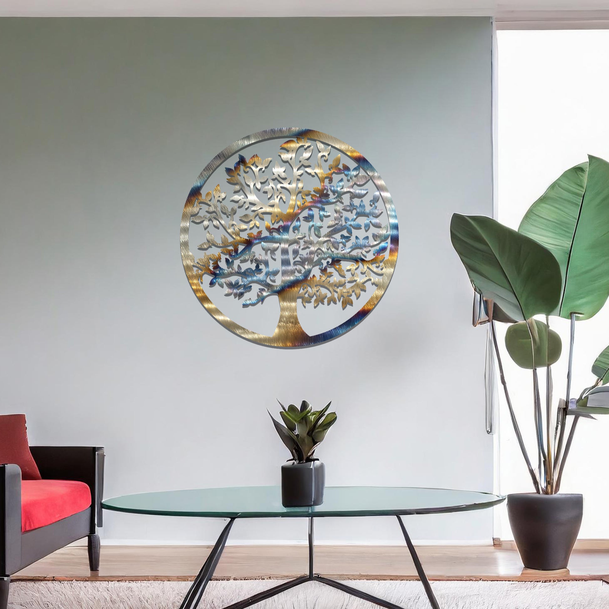 Metal wall art featuring a circular design with a detailed tree of life motif, showcasing intricate branches and leaves, mounted on a neutral wall within modern room decor. The elegant craftsmanship and symbolic design add a touch of sophistication and meaning to the space.