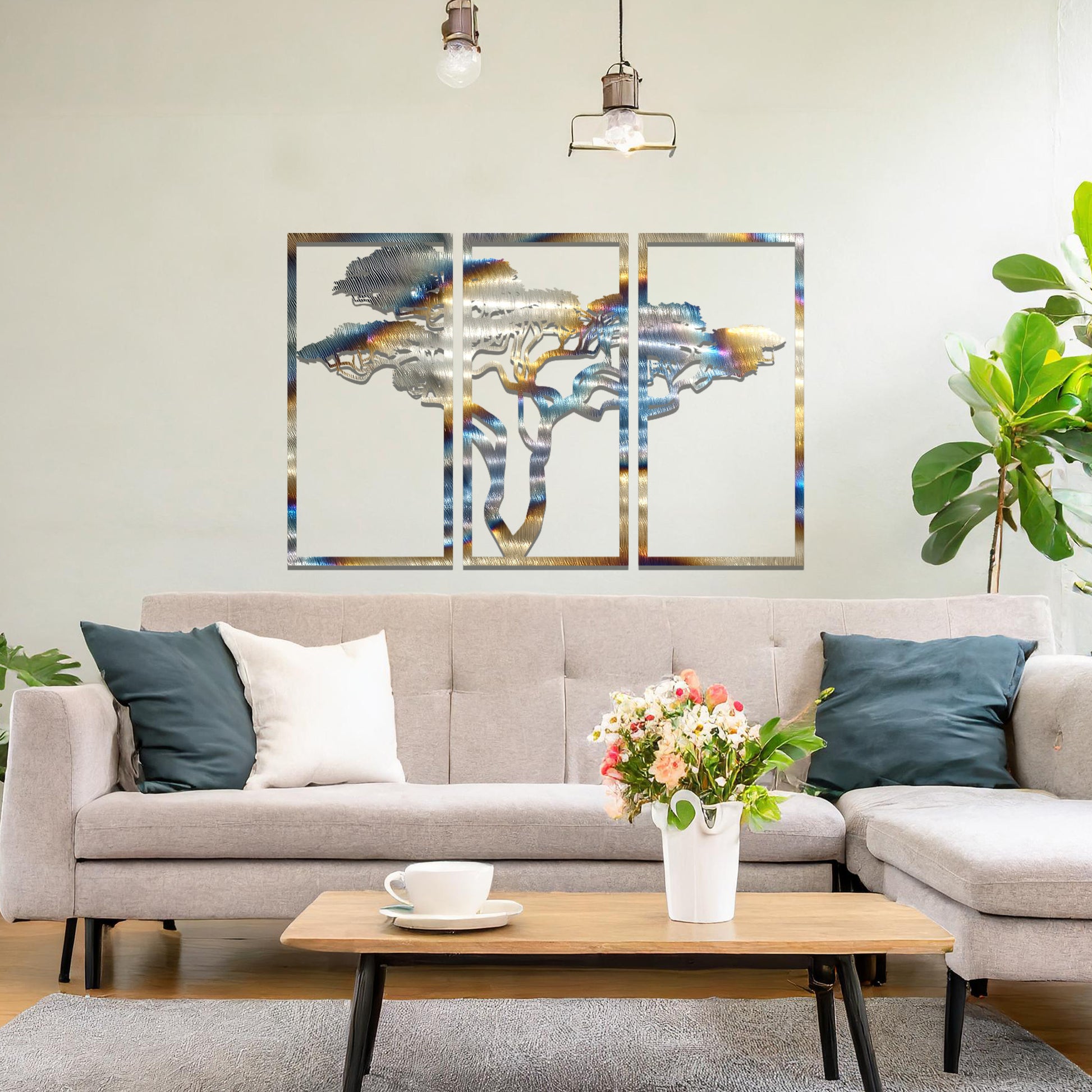 Metal wall art featuring a three-panel design with a stylised tree silhouette, mounted on a neutral wall within a modern artistic setting. The rust finish and detailed tree branches create a natural and calming focal point for the room.