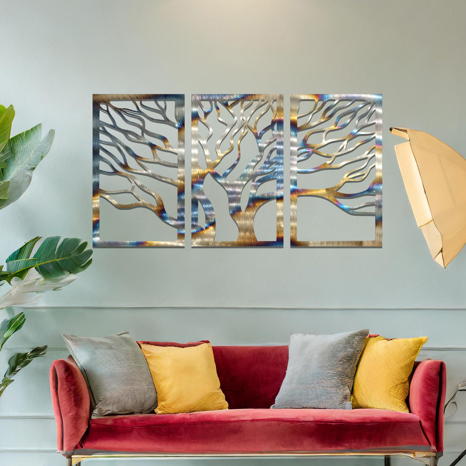 Three-panel metal wall art featuring intricately cut tree branches in a flowing design, creating a dynamic and organic effect.