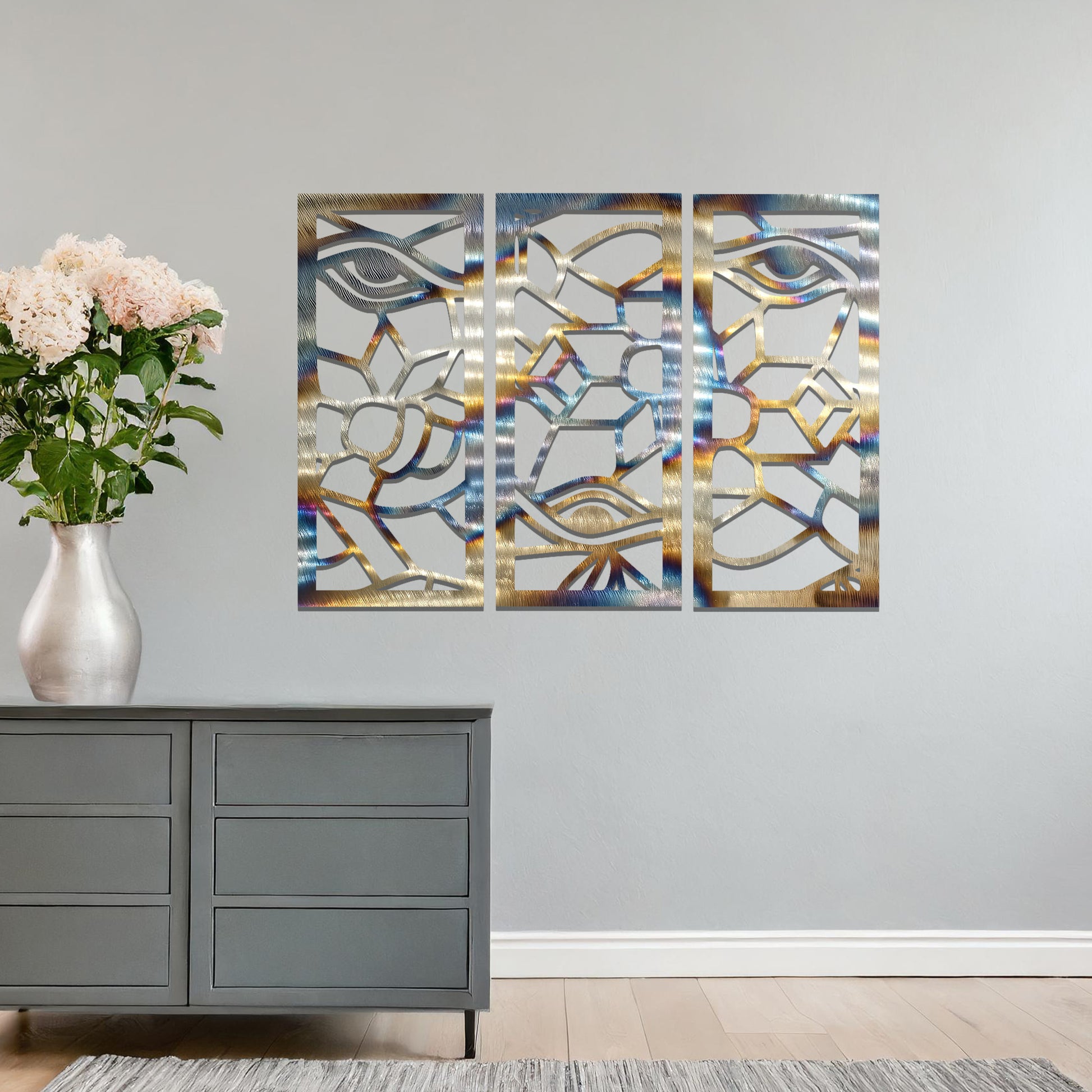 Decorative metal wall art featuring a set of three geometric panels with intricate abstract designs, mounted on a neutral wall within modern room decor. The focus is on the unique craftsmanship and harmonious composition of the wall art, enhancing the contemporary aesthetic of the space.