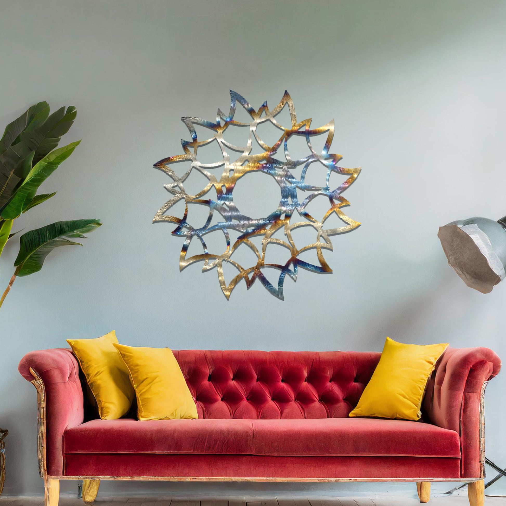 Metal wall art featuring a circular floral-inspired design with layered petal-like patterns, crafted with precise laser-cut detailing, displayed on a neutral wall within modern decor.