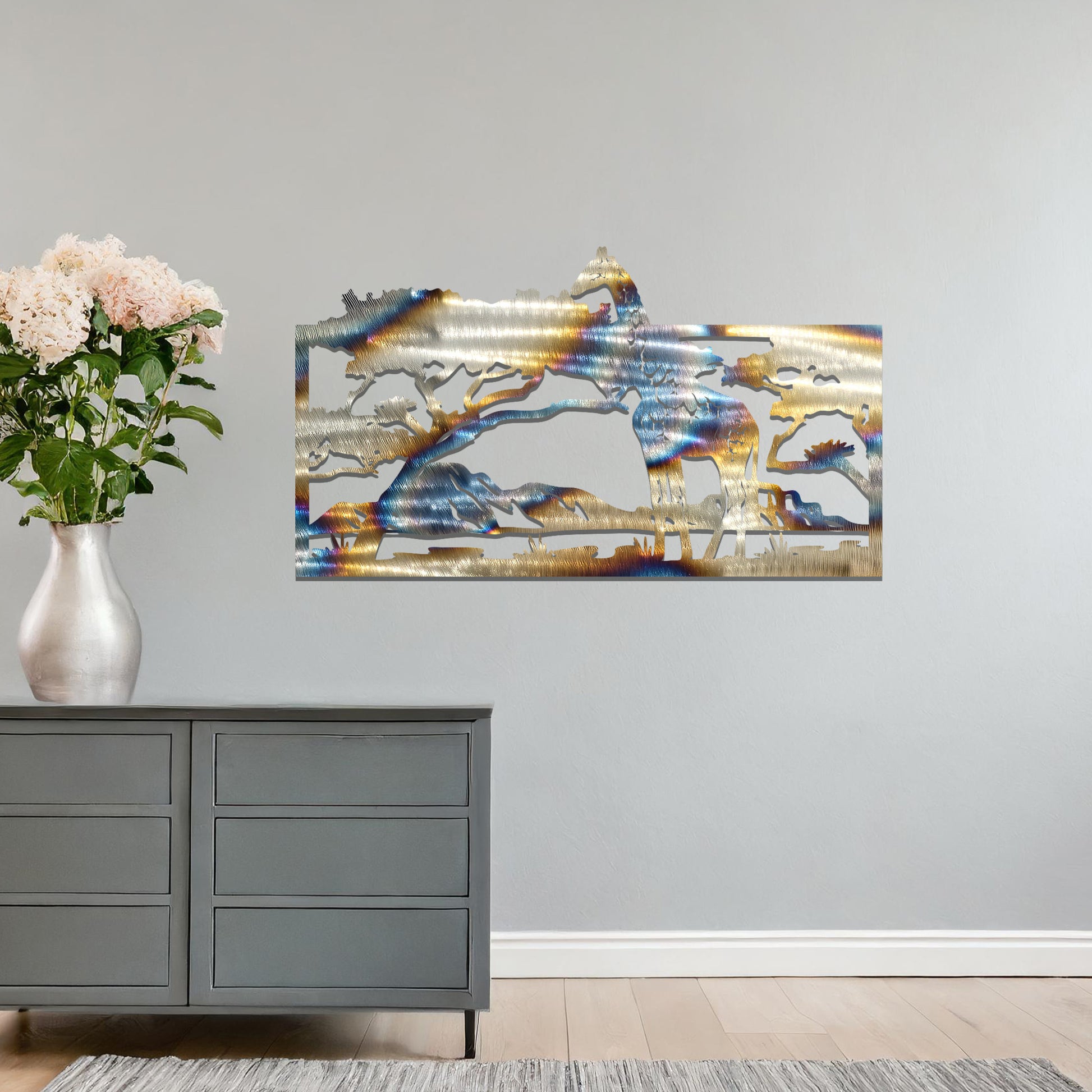 A stunning wall art piece showcasing a giraffe standing gracefully beneath a tree, set against a backdrop of mountains and an expansive savanna landscape. Perfect for bringing an essence of wildlife into your space.