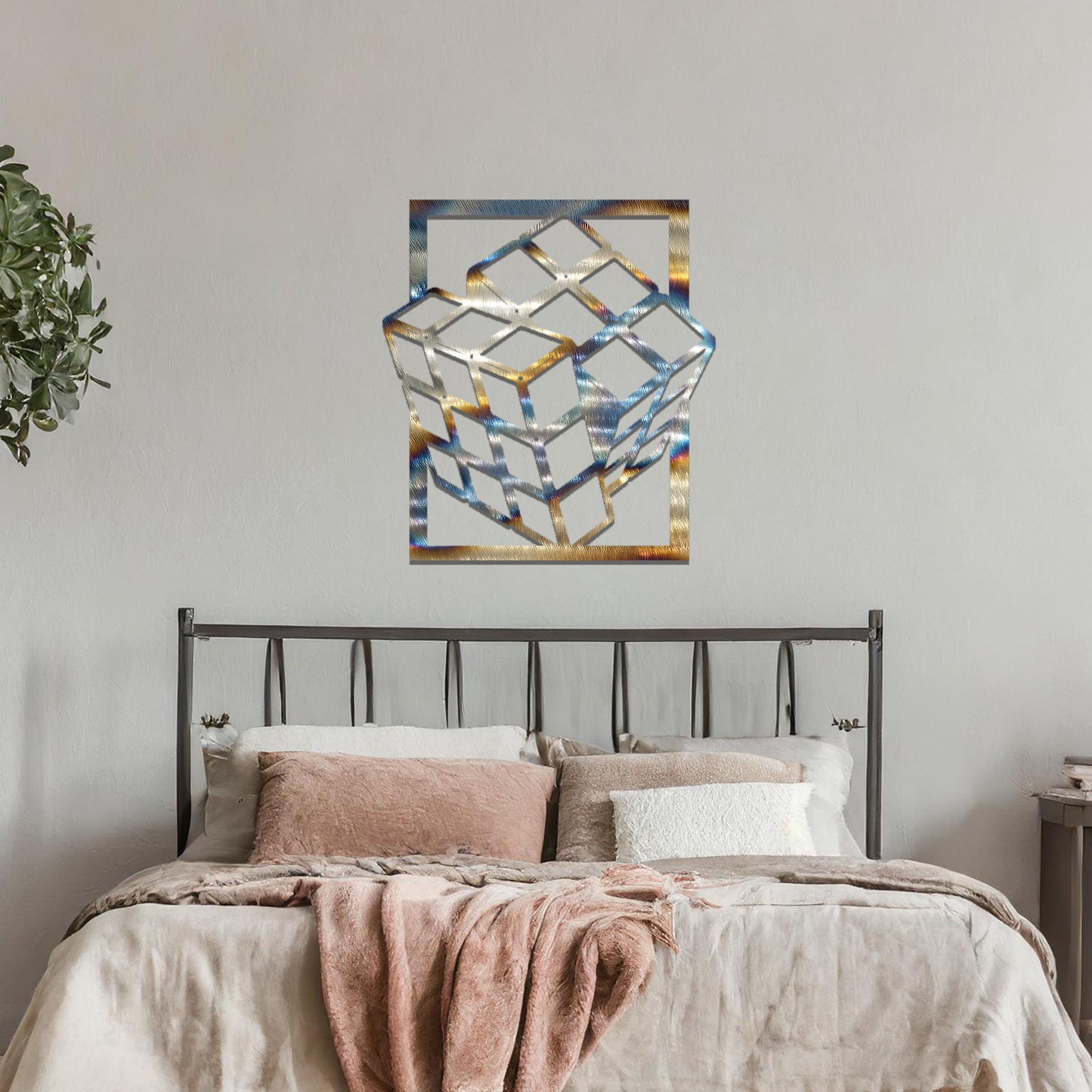 Metal wall art featuring a rectangular design of a three-dimensional cube, showcasing bold geometric shapes and a modern aesthetic as a statement piece.