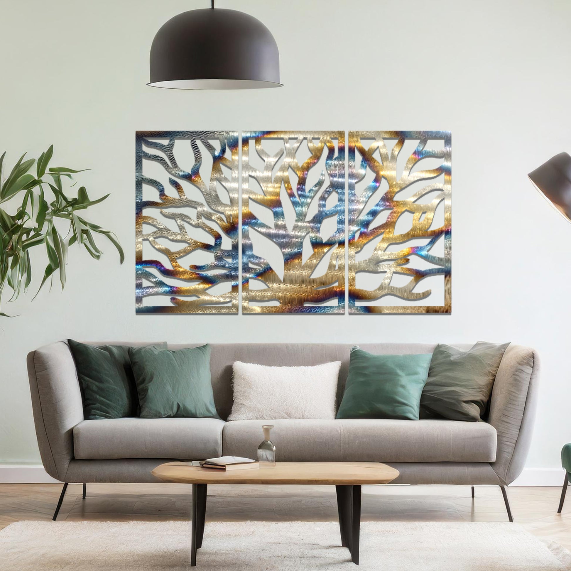 Metal wall art featuring a three-panel design of a tree with intricate branching patterns, crafted with precise laser-cut detailing, placed on a neutral wall within modern decor.