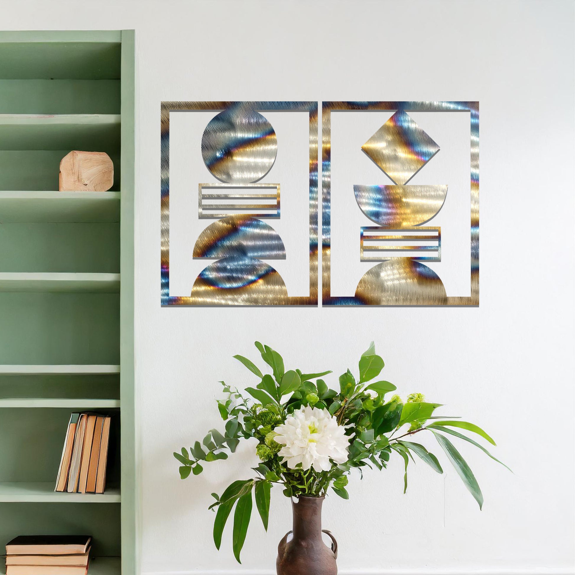 A metal wall art set featuring geometric shapes, including circles and a diamond, arranged in a balanced and symmetrical design. The art is displayed on a neutral wall within modern room decor, adding an elegant and abstract touch to the space.