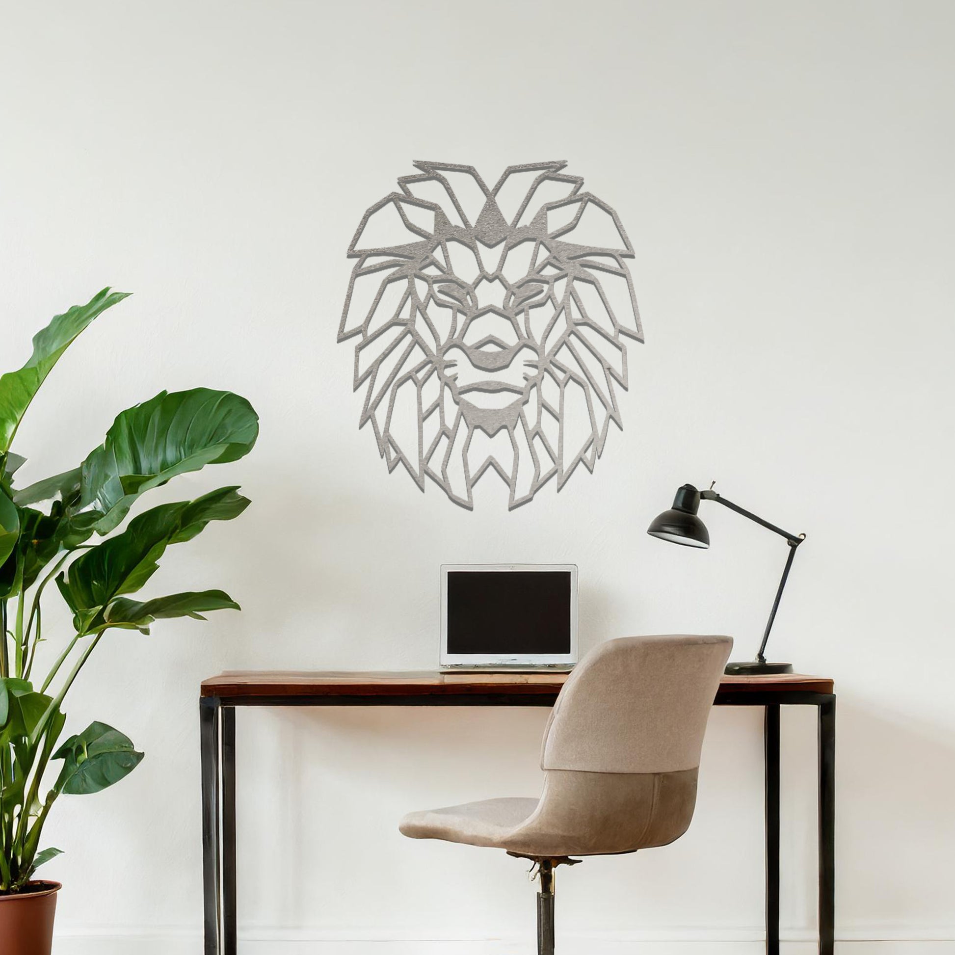 Metal wall art featuring a geometric lion head design with intricate angular detailing, crafted with precise laser-cut techniques, displayed on a neutral wall within modern decor.