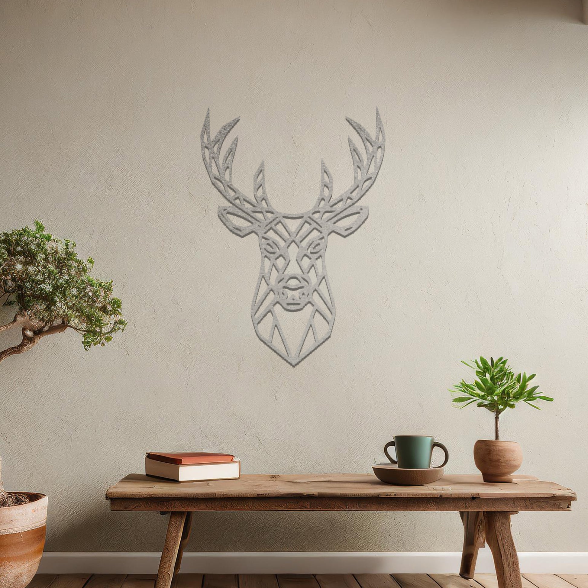 Metal wall art featuring a geometric deer head design with intricate detailing, crafted with precise laser-cut techniques, displayed on a neutral wall within modern decor.