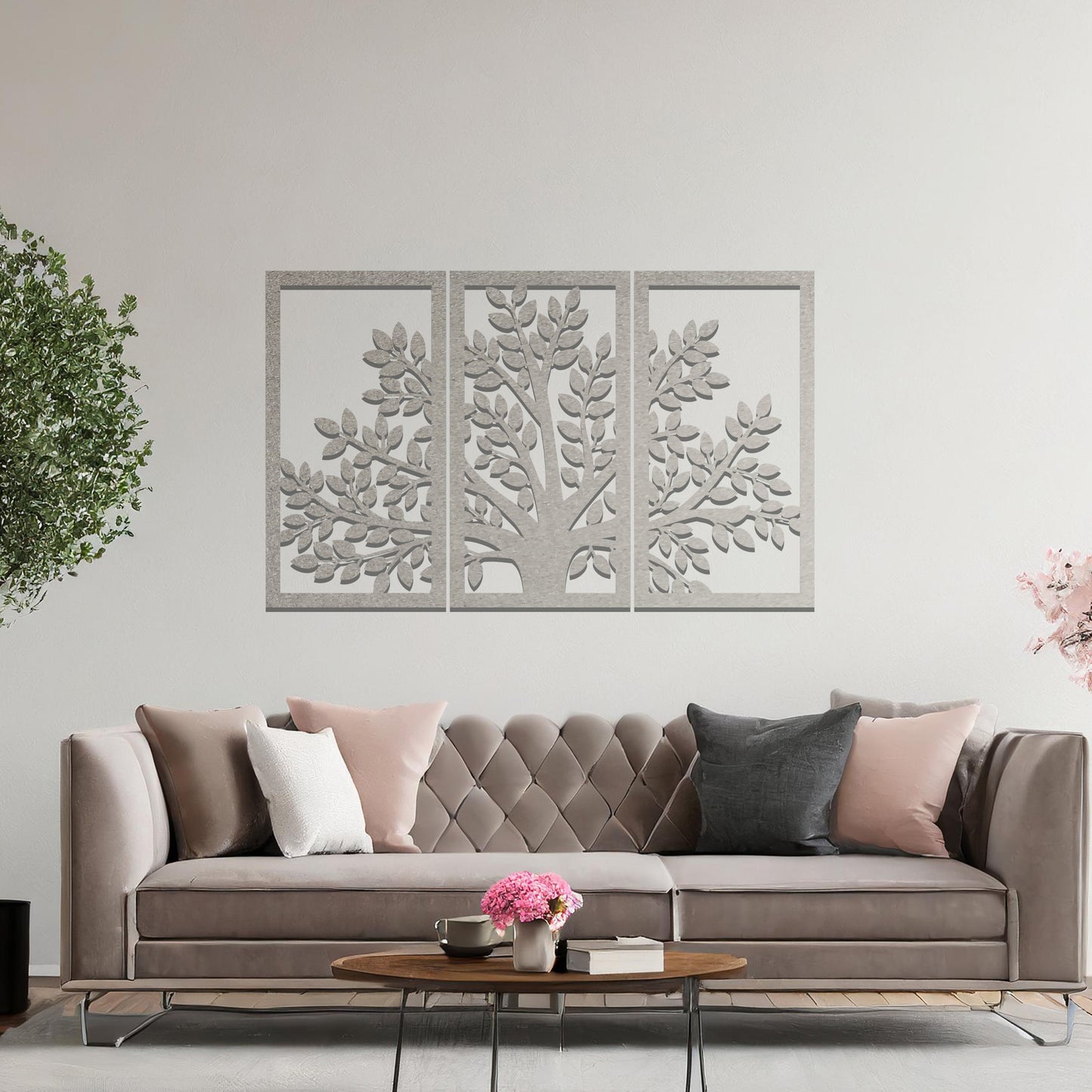 Metal wall art featuring a three-panel tree design with a detailed trunk, branches, and clustered leaves, crafted with precise laser-cut detailing, displayed on a neutral wall within modern decor.
