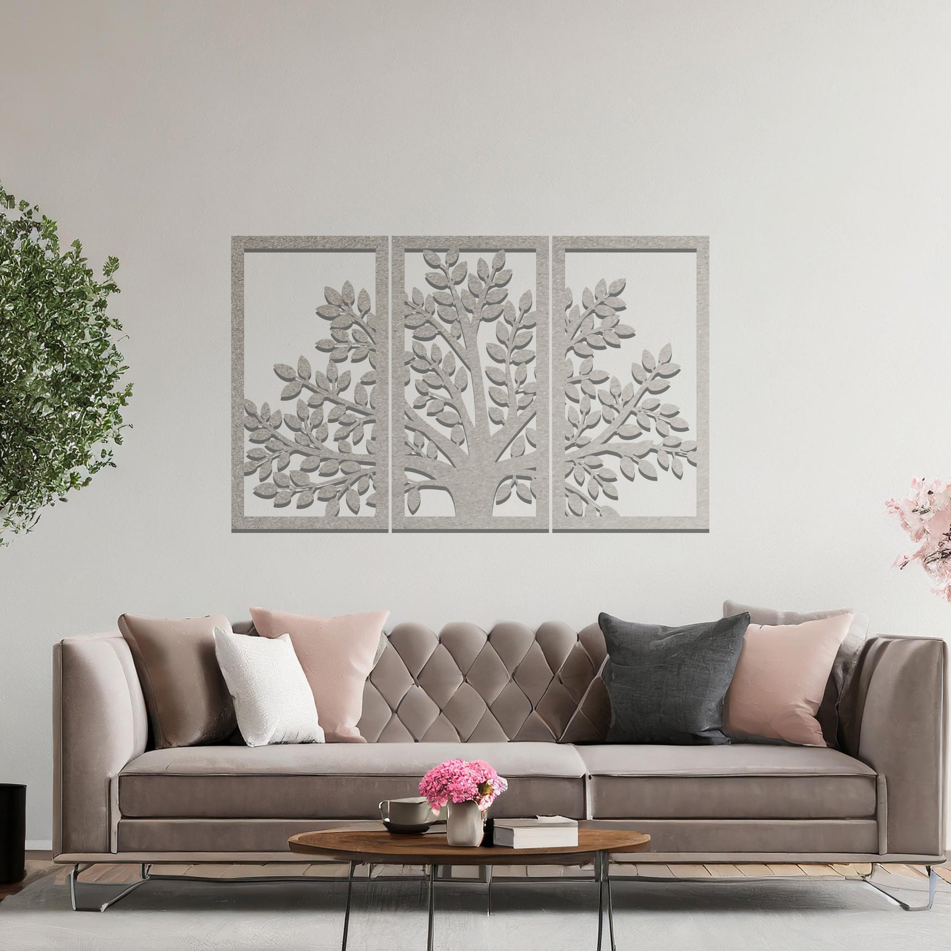 Metal wall art featuring a three-panel tree design with a detailed trunk, branches, and clustered leaves, crafted with precise laser-cut detailing, displayed on a neutral wall within modern decor.