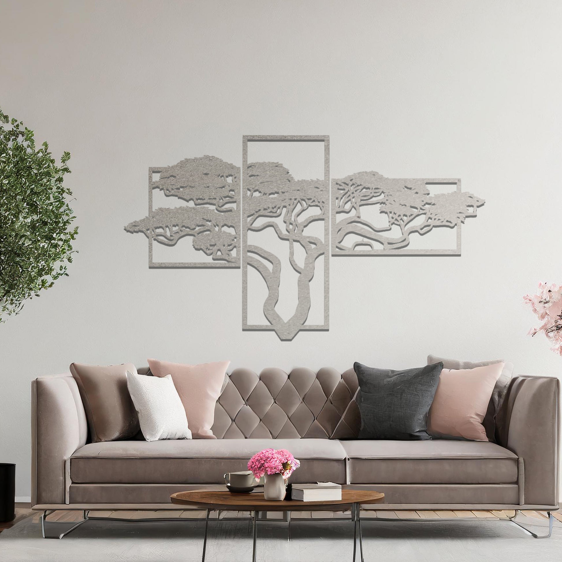 Metal wall art featuring a multi-panel tree design with a detailed branching structure, crafted with precise laser-cut techniques, displayed on a neutral wall within modern decor.