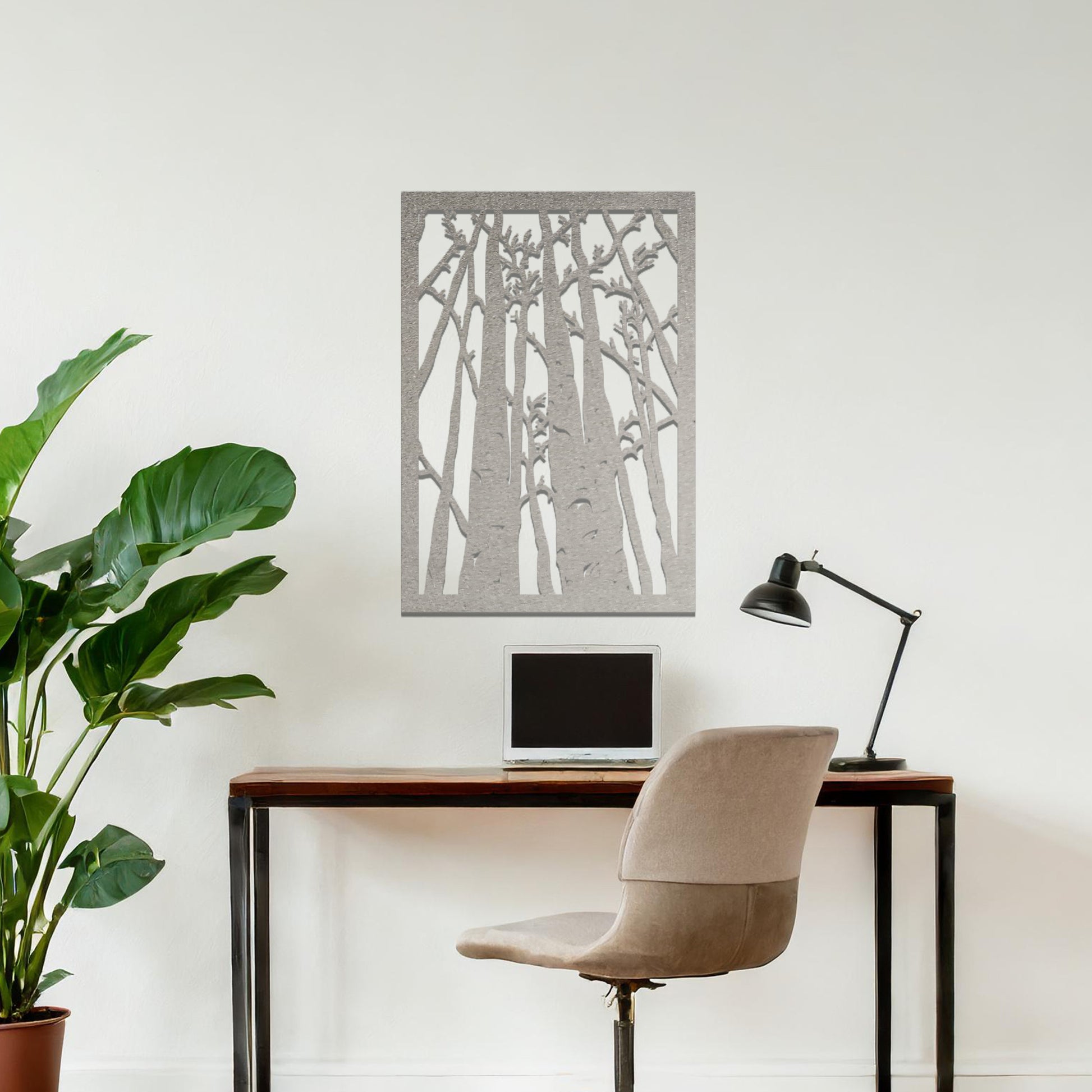 Metal wall art featuring a rectangular design of tall trees with bare branches, showcasing intricate details, displayed on a neutral wall within modern decor.