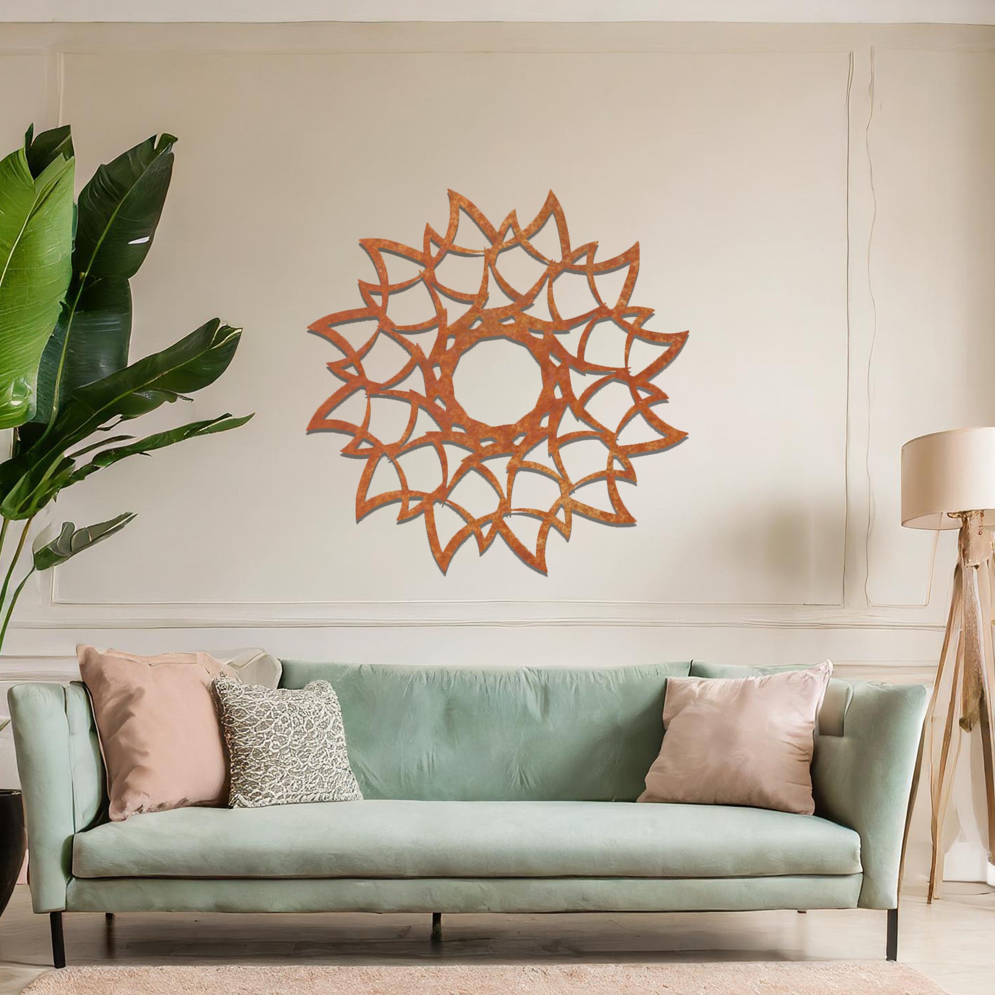 Metal wall art featuring a circular floral-inspired design with layered petal-like patterns, crafted with precise laser-cut detailing, displayed on a neutral wall within modern decor.