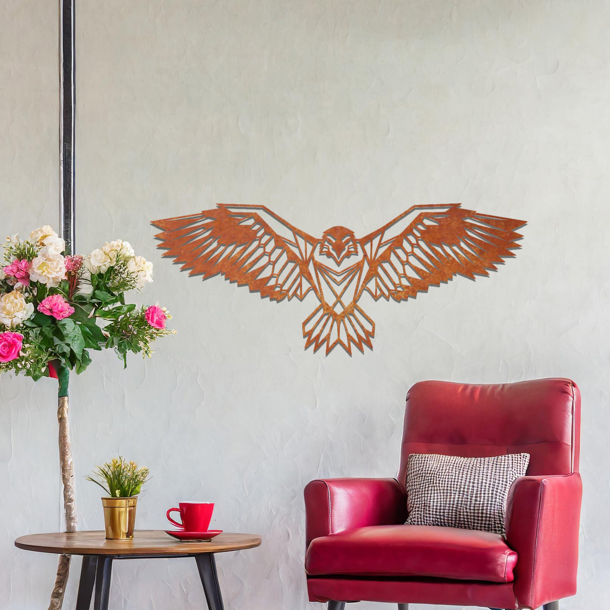 Metal wall art featuring a geometric eagle design with outstretched wings and intricate detailing, crafted with precise laser-cut techniques, displayed on a neutral wall within modern decor.