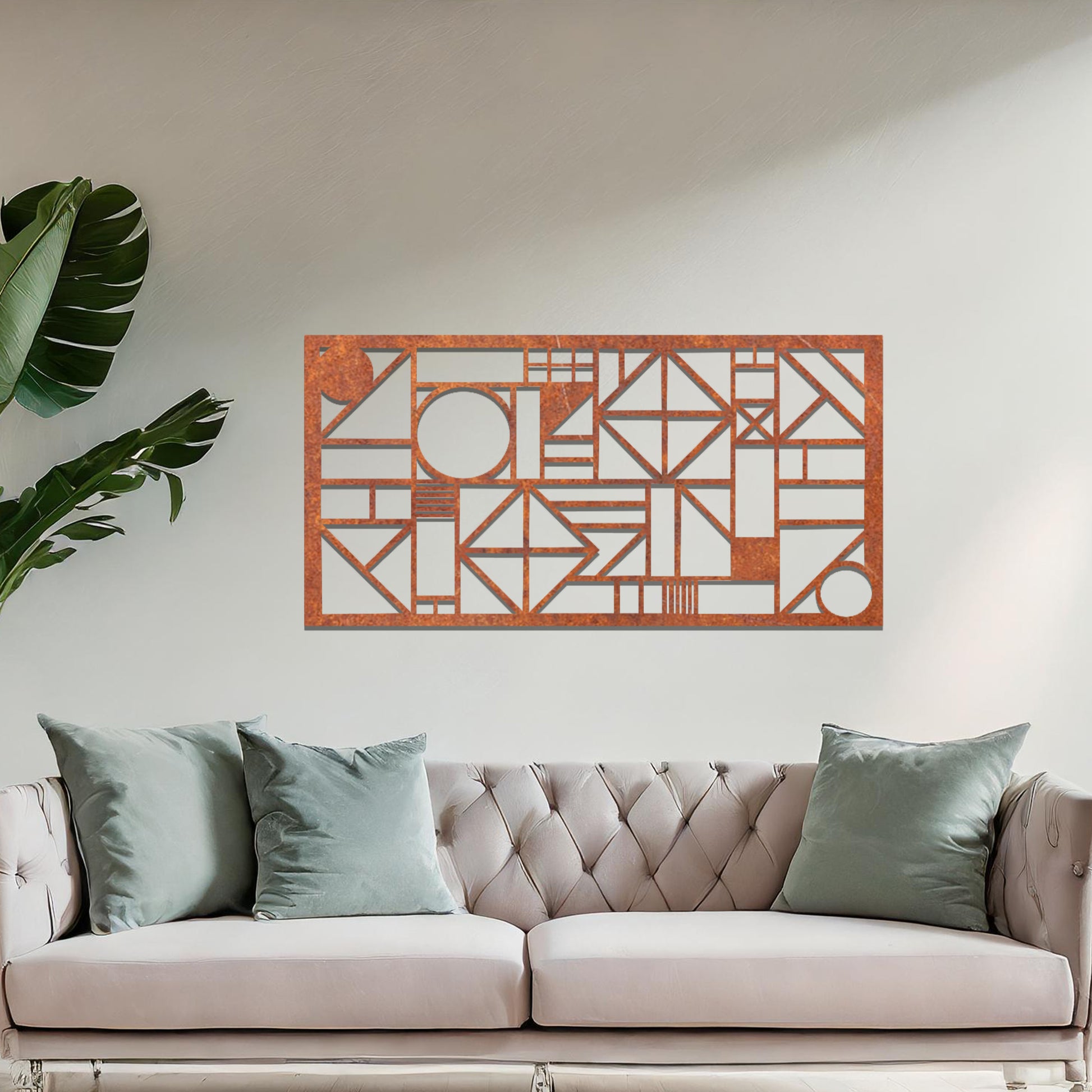 Metal wall art with a geometric design, featuring various abstract shapes, lines, and angles arranged in a structured composition. The art is placed on a neutral wall within modern room decor, adding an artistic touch to the space.