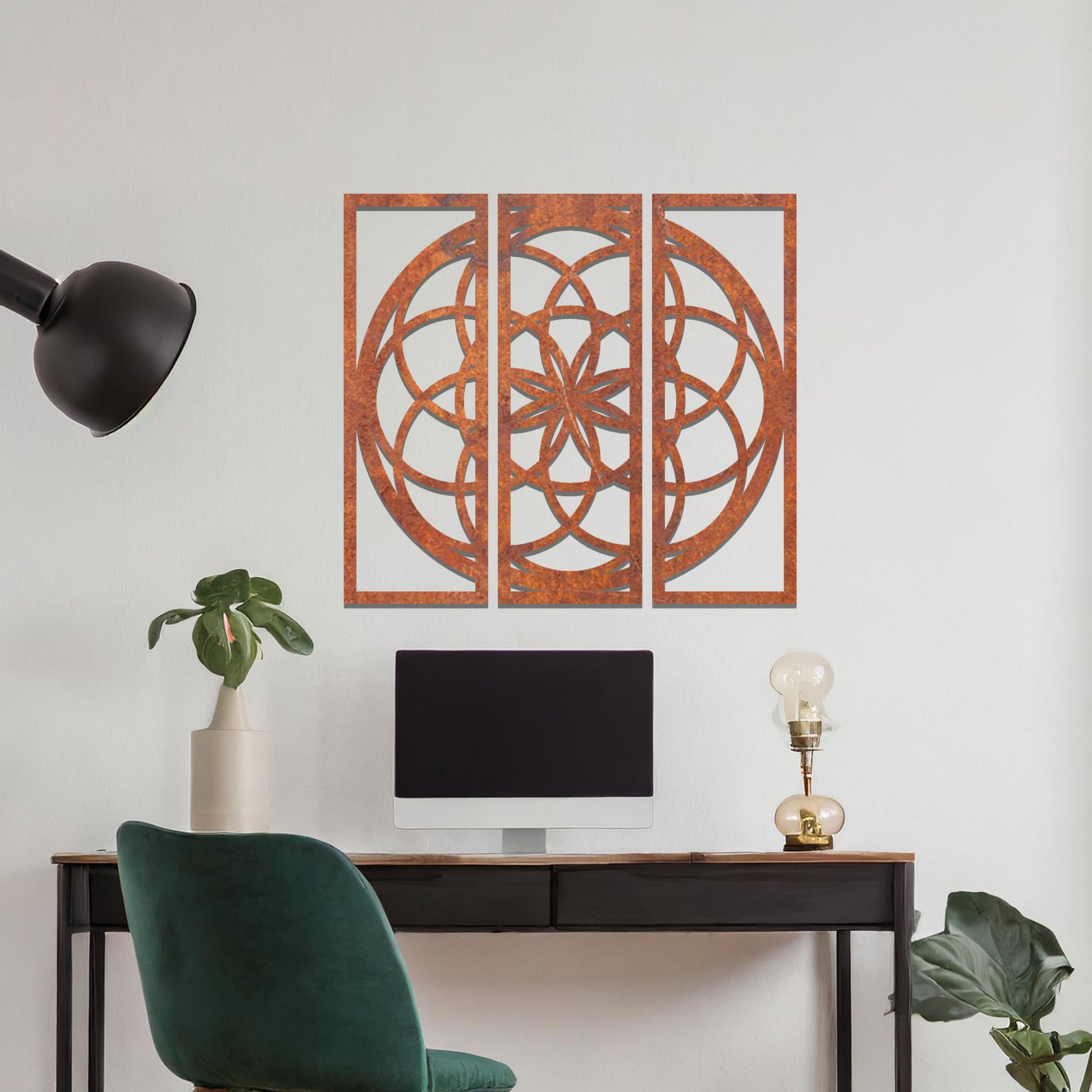 A three-panel metal wall art featuring a geometric floral pattern with interlocking circles and a star-shaped center. The design is displayed on a neutral wall, enhancing the room's modern aesthetic with its elegant symmetry.
