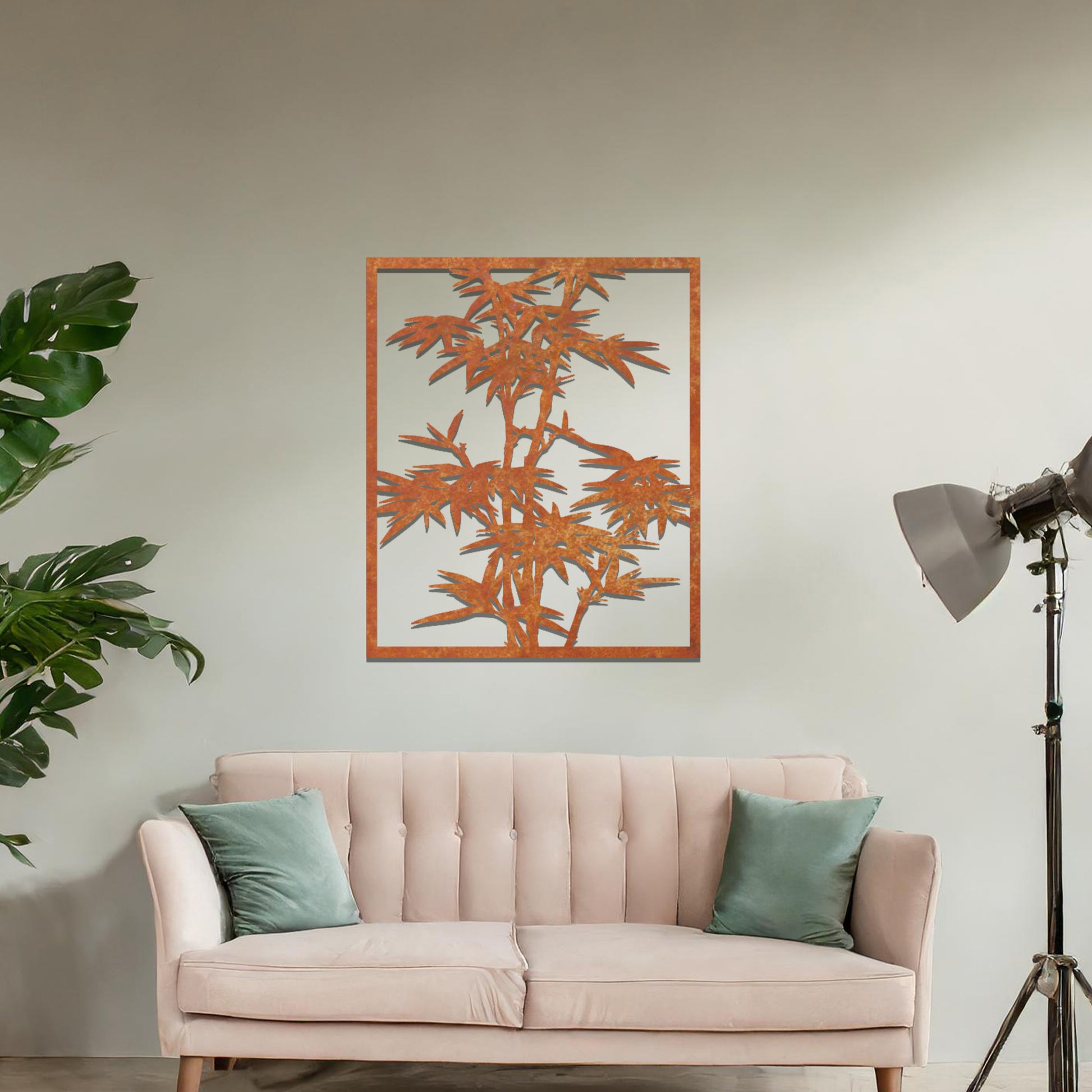 Metal wall art featuring a rectangular design of bamboo stalks with detailed leaves, creating an elegant and nature-inspired accent for the living space.