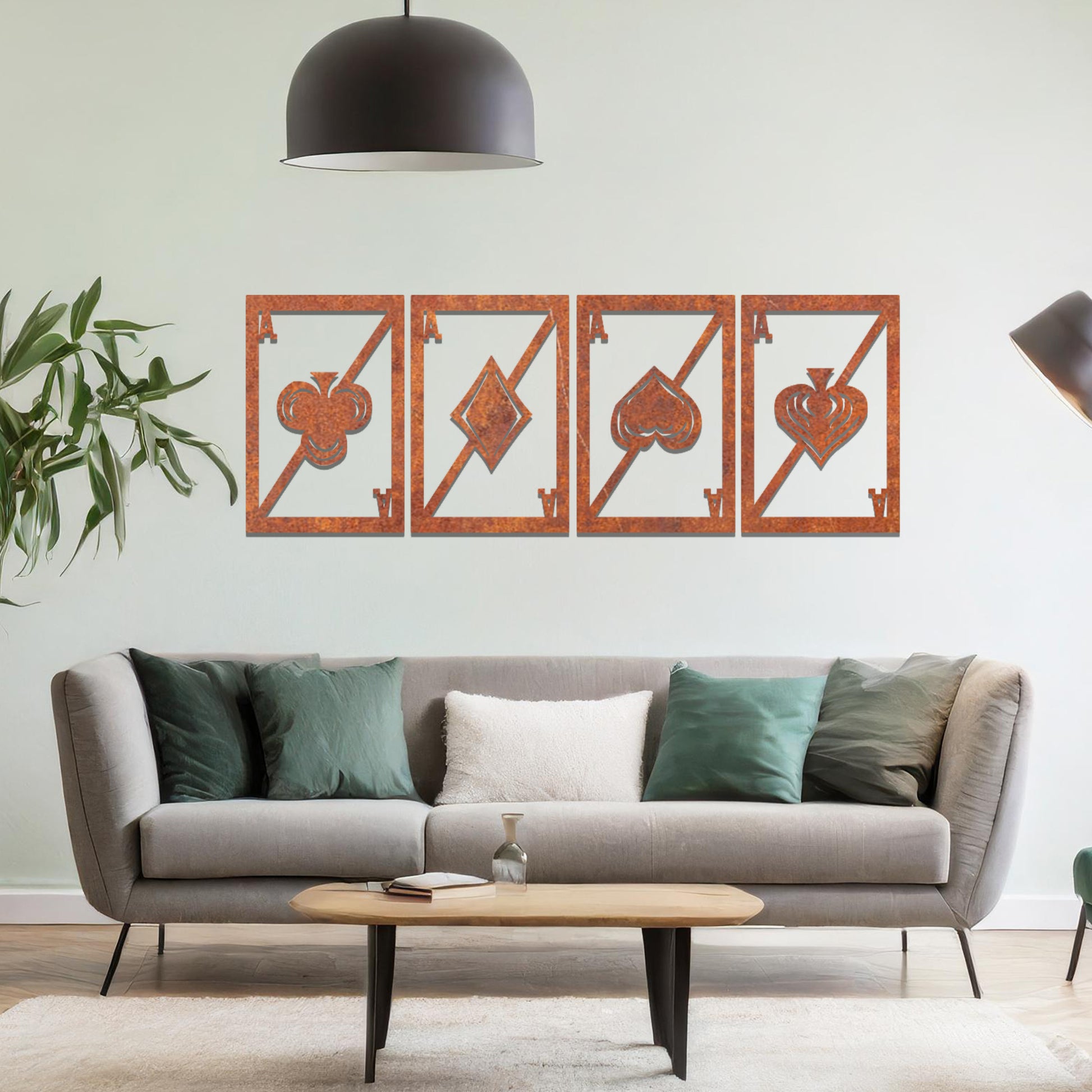 Metal wall art featuring a four-panel design inspired by playing card suits—clubs, diamonds, hearts, and spades—each framed with a modern aesthetic, creating a bold statement piece in the interior setting.