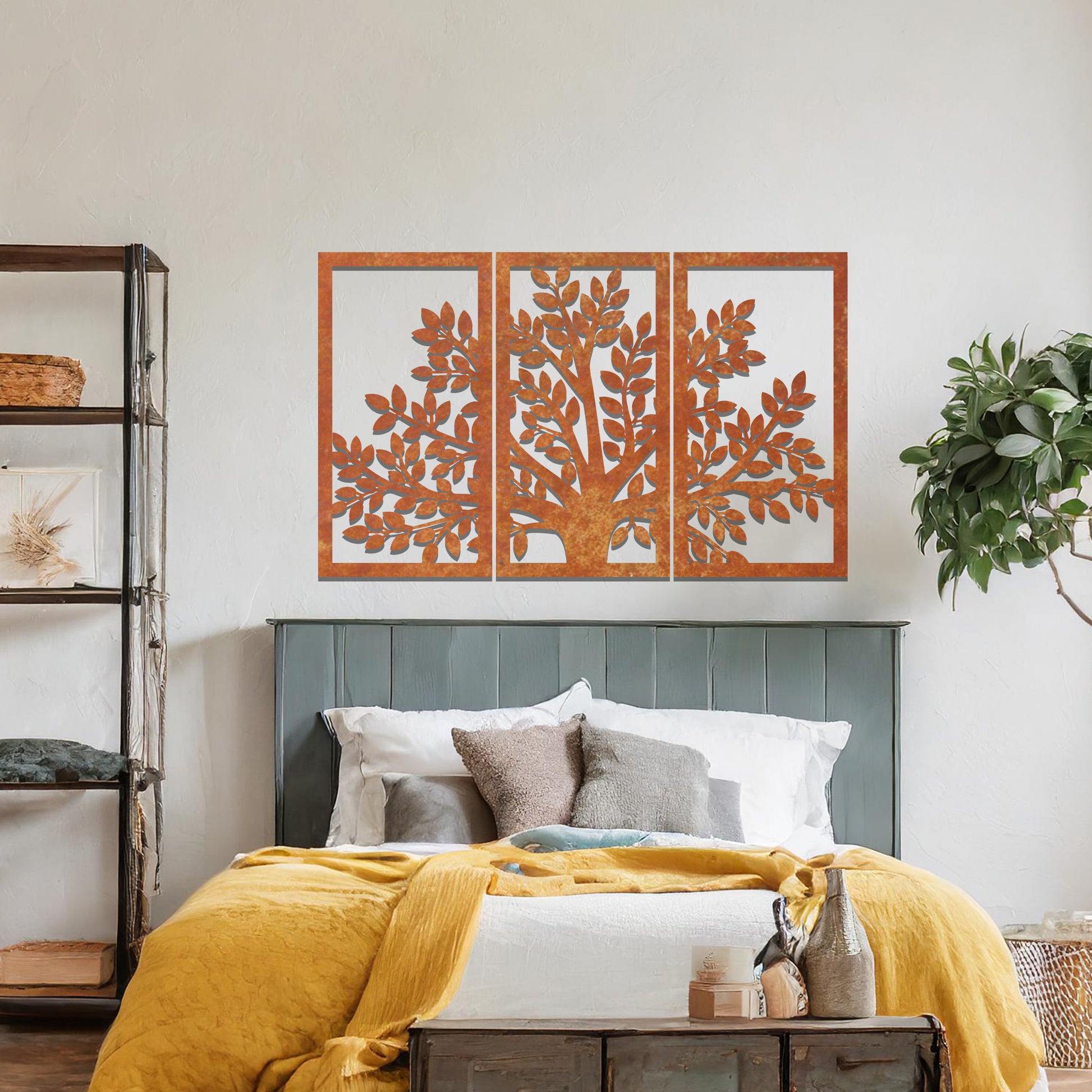 Metal wall art featuring a three-panel tree design with a detailed trunk, branches, and clustered leaves, crafted with precise laser-cut detailing, displayed on a neutral wall within modern decor.