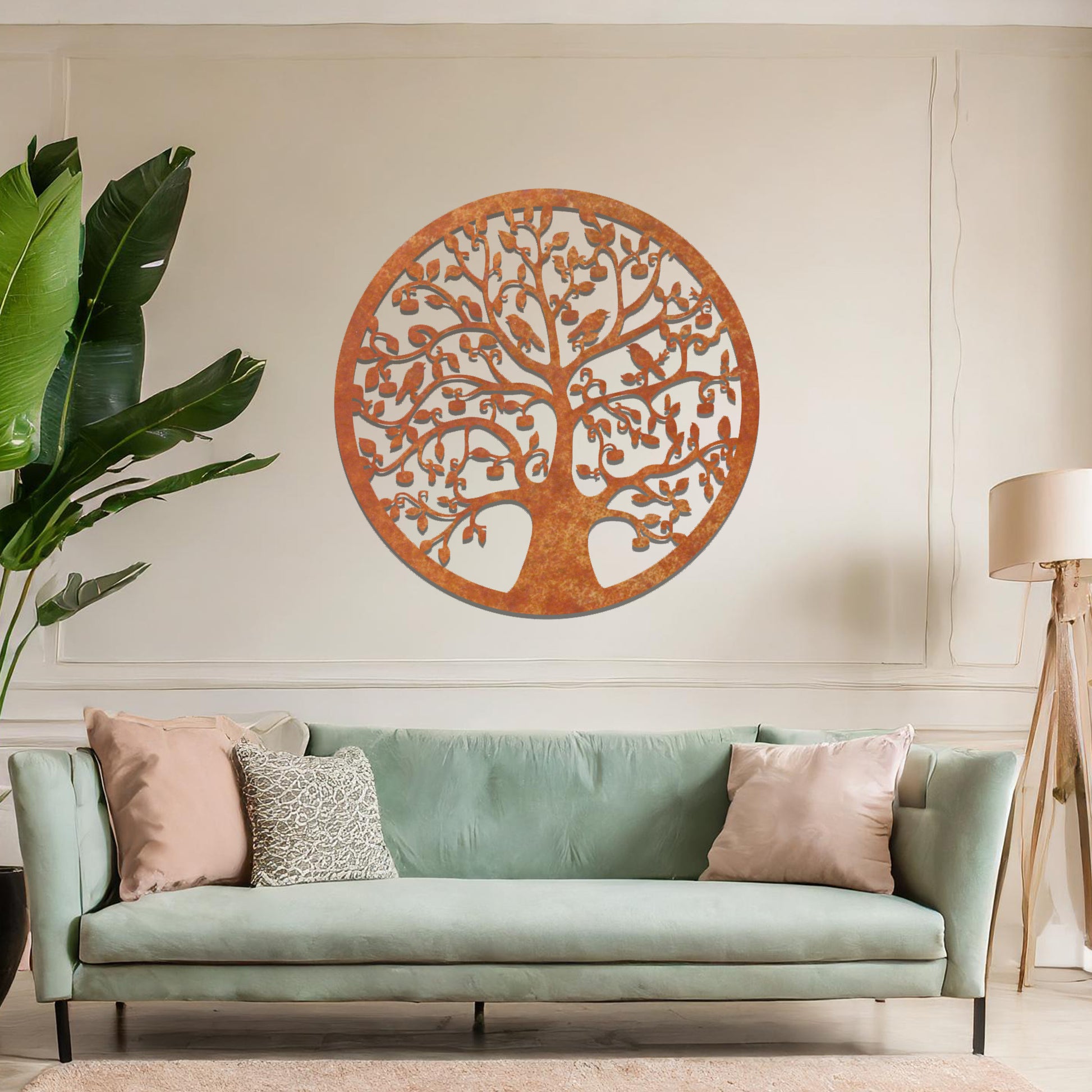 Metal wall art featuring a circular tree design with intricate branches and leaves, showcasing a detailed and balanced composition, displayed on a neutral wall within modern decor.