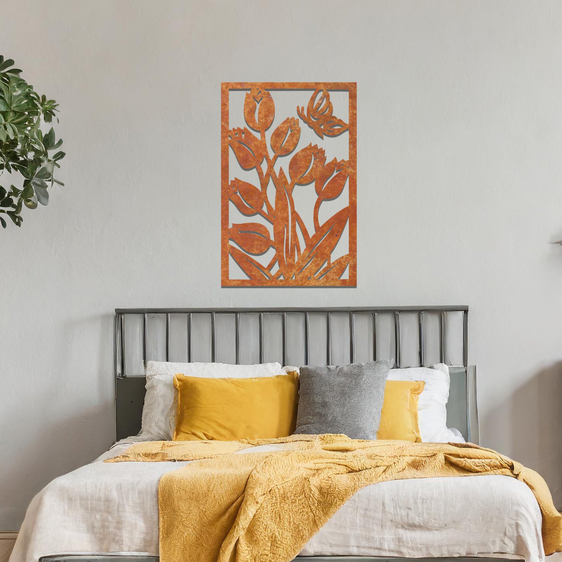 Metal wall art depicting tulips with a butterfly hovering above them. The design captures the beauty of nature, placed on a neutral wall within modern room decor, enhancing the fresh and vibrant feel of the space.