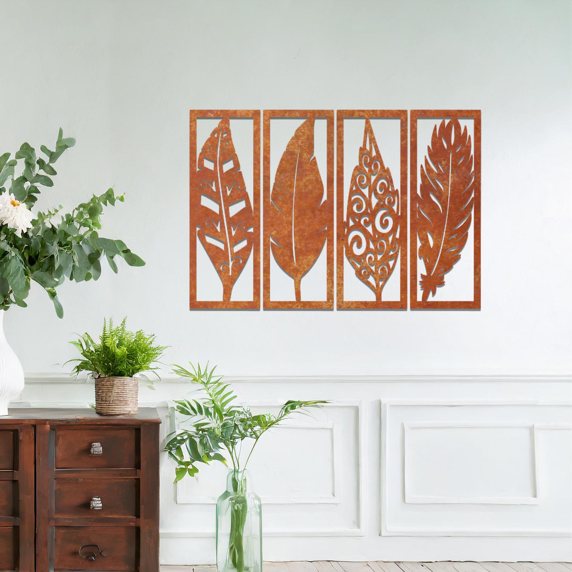 Metal wall art featuring five rectangular panels with detailed leaf designs, each panel showcasing a unique pattern. The art is mounted on a neutral wall within a modern office setting, adding a natural touch to the workspace decor.