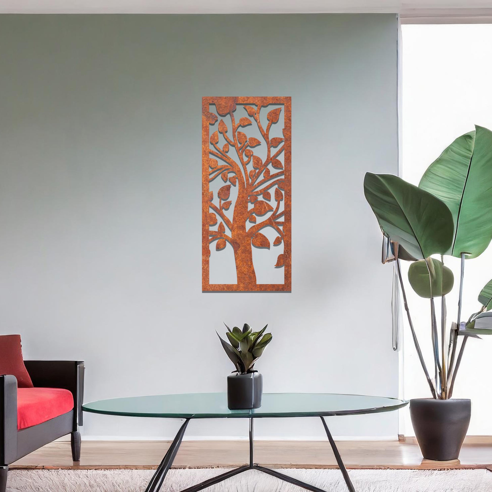 Metal wall art featuring a rectangular design with a stylised tree motif, showcasing flowing branches and leaves, mounted on a neutral wall within modern room decor. The minimalist craftsmanship adds a sleek and natural aesthetic, enhancing the contemporary elegance of the space.
