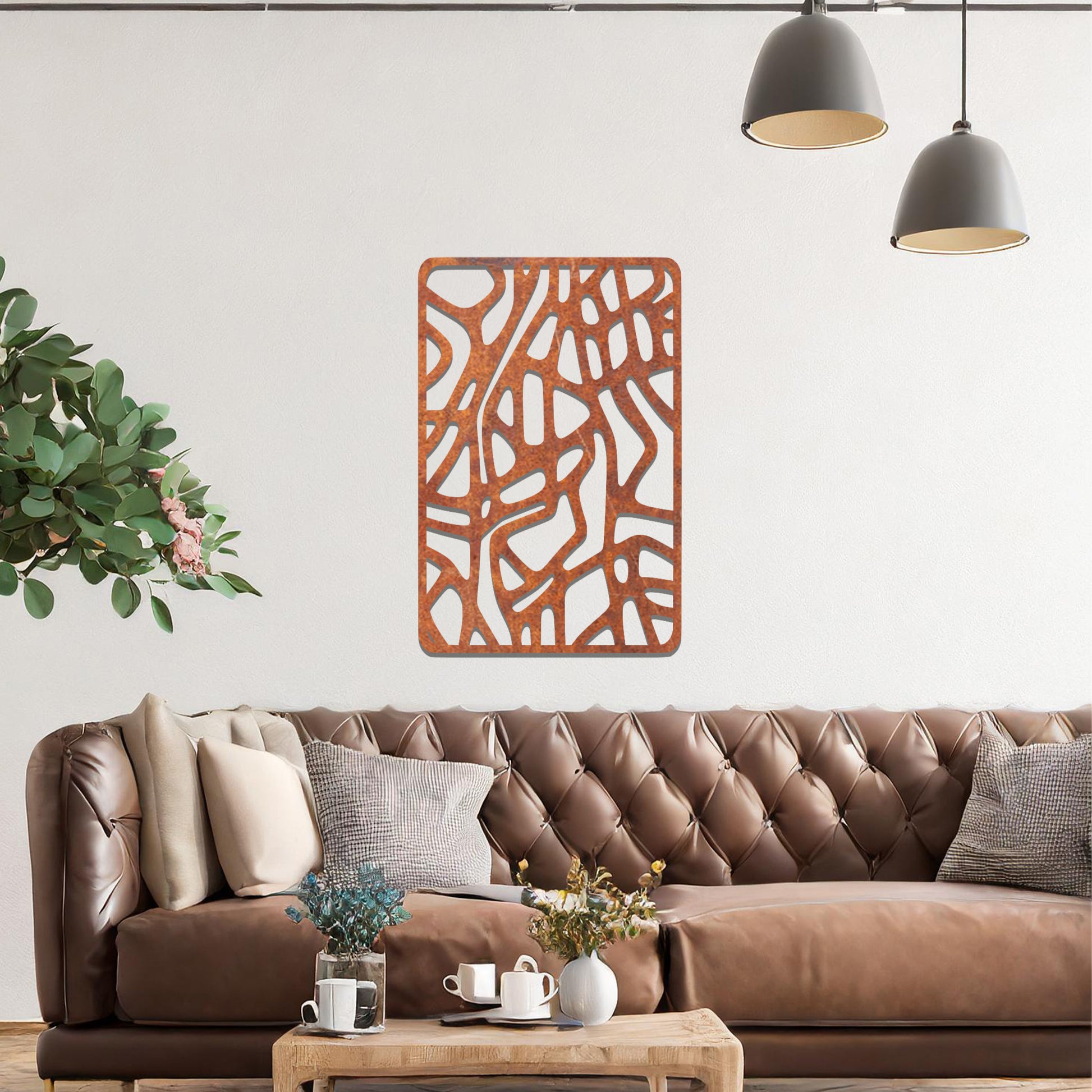 Metal wall art featuring an abstract design with interconnected lines and shapes, creating an organic pattern. The art is placed on a neutral wall within modern living room decor, enhancing the contemporary style of the space.