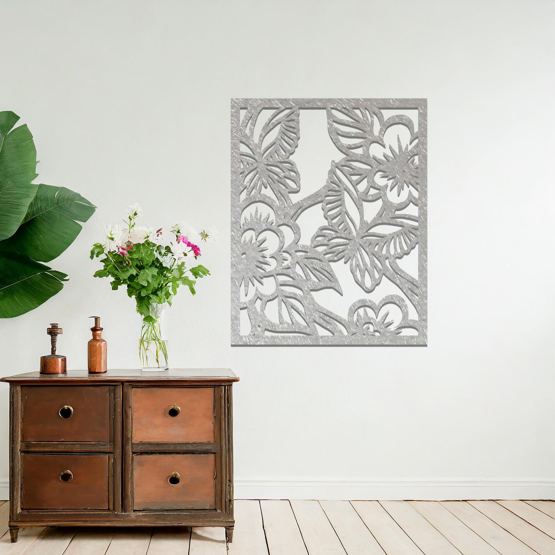 Metal wall art featuring a square design with a floral motif of blooming flowers and intricate leaves, mounted on a neutral wall within modern bedroom decor. The delicate detailing and natural theme create a soothing and elegant focal point, enhancing the space's aesthetic.