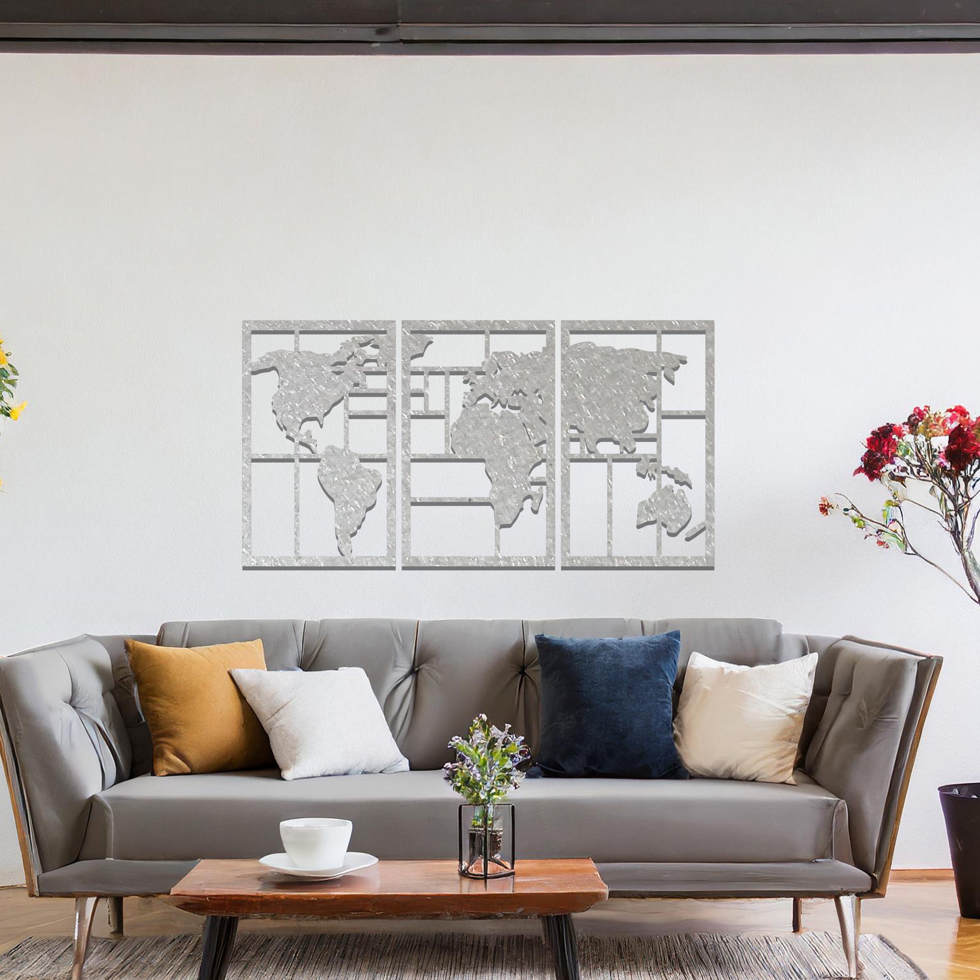 Metal wall art featuring a three-panel design of a world map with geometric patterns. The map is displayed in a contemporary layout, and the art is placed on a neutral wall within modern room decor, offering a stylish global touch to the space.
