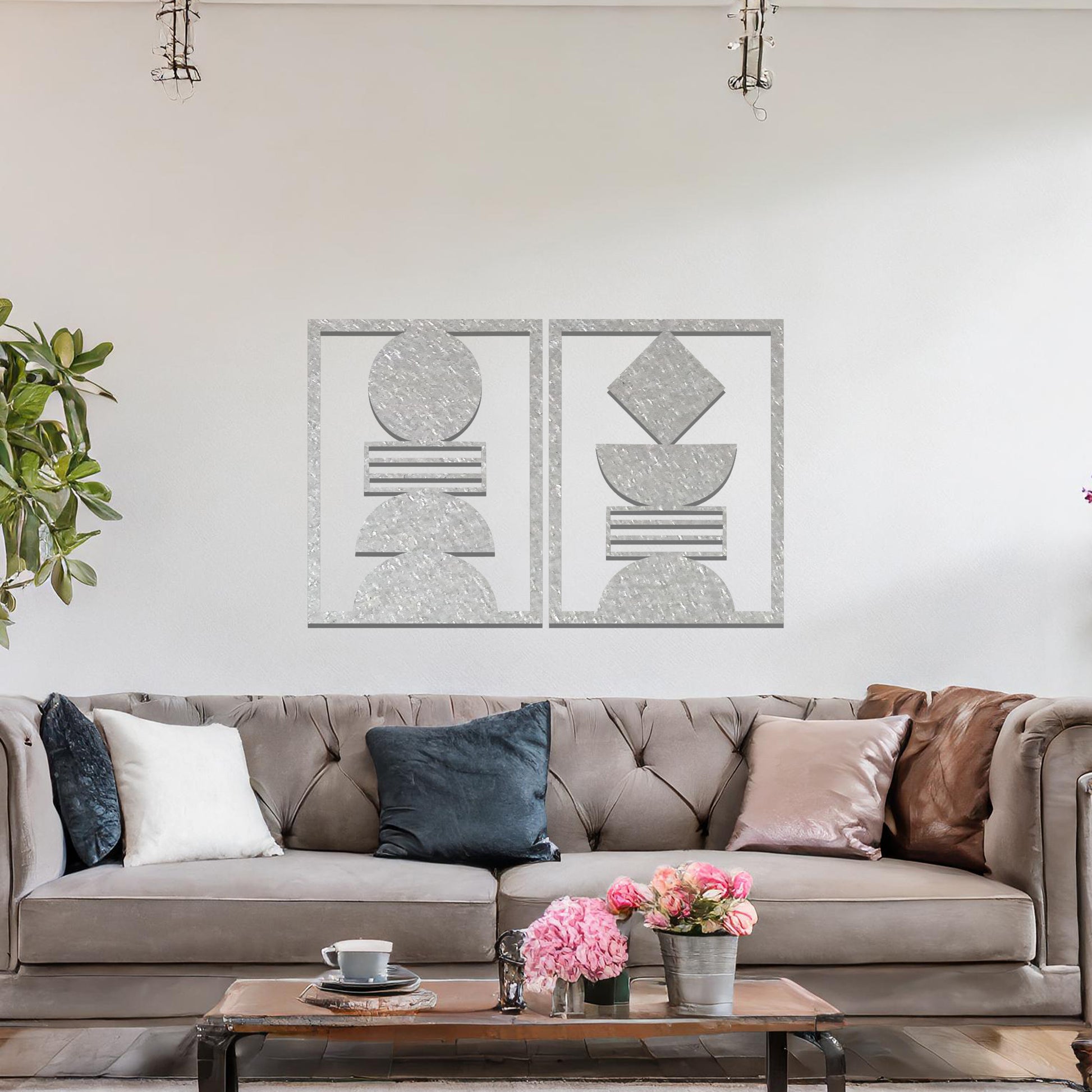 A metal wall art set featuring geometric shapes, including circles and a diamond, arranged in a balanced and symmetrical design. The art is displayed on a neutral wall within modern room decor, adding an elegant and abstract touch to the space.