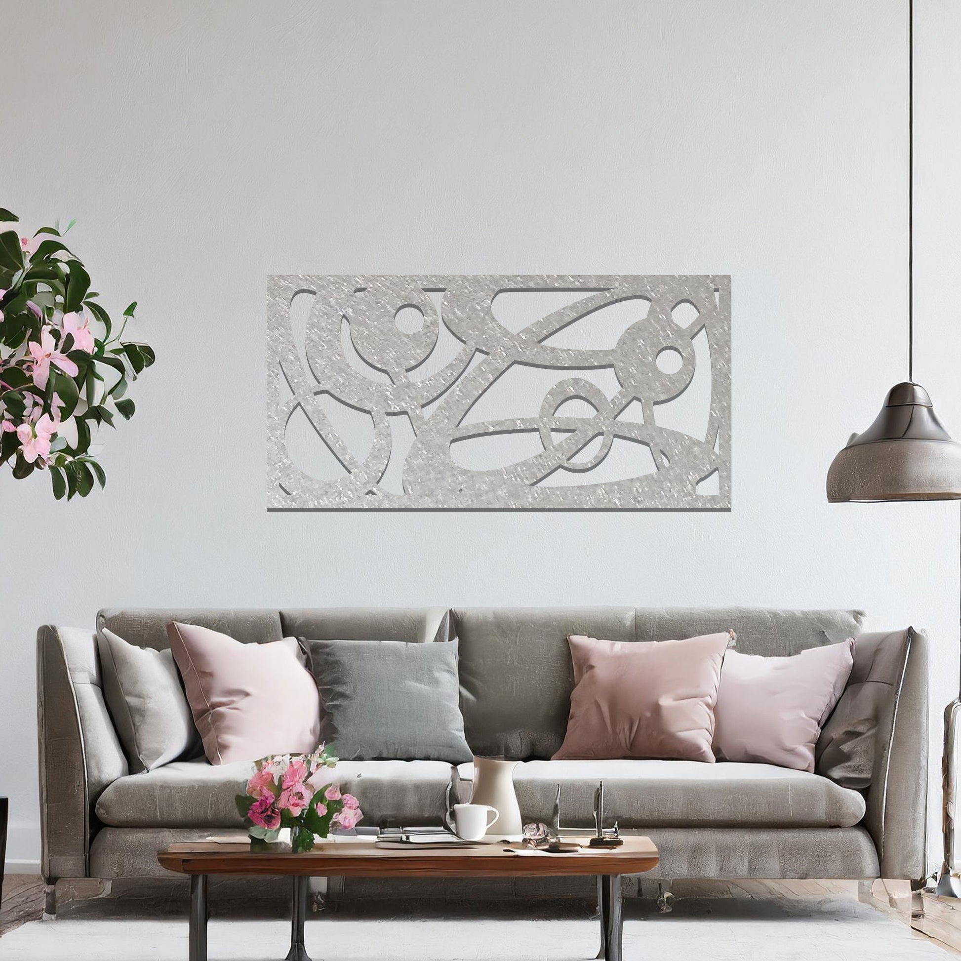 Metal wall art featuring a long, rectangular design with abstract swirling patterns and geometric shapes, mounted on a neutral wall within modern decor. The bold lines and shapes create an eye-catching focal point, adding a touch of artistic flair to the space.