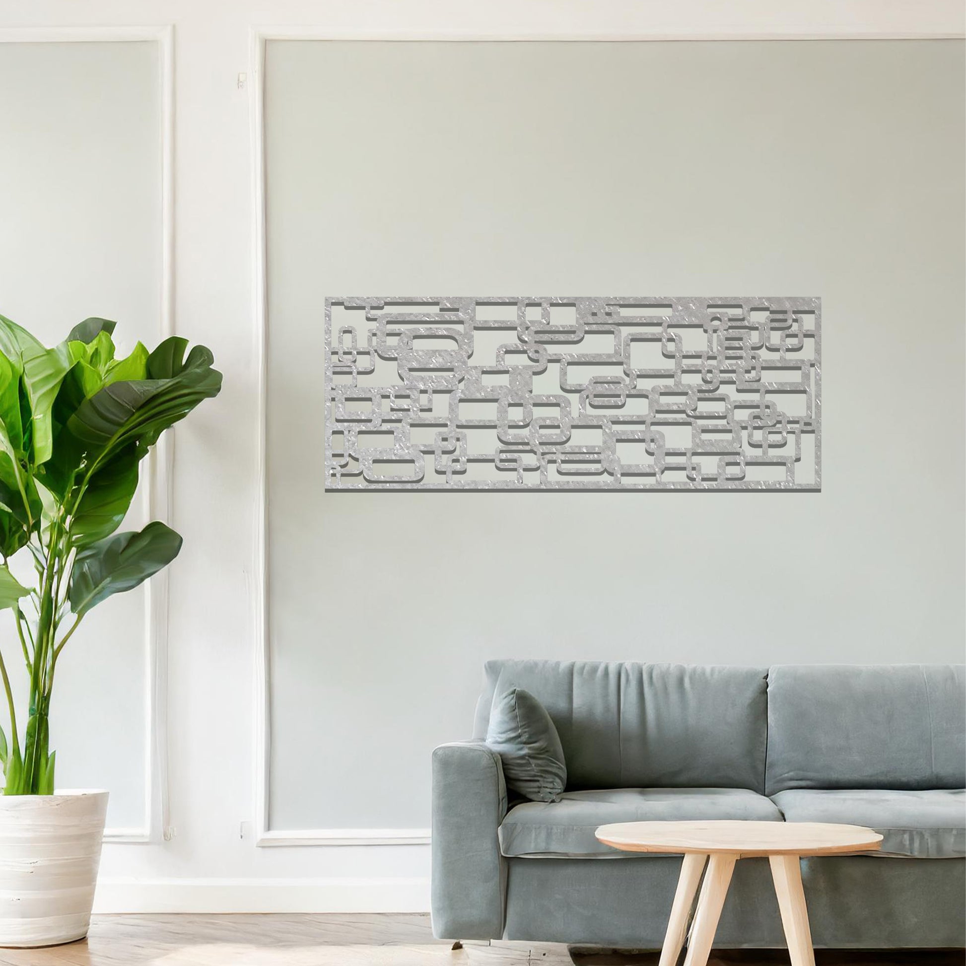Metal wall art featuring an abstract geometric design with overlapping and interlocking rectangular shapes. The artwork is placed on a neutral wall in a modern living room, complementing contemporary decor with its dynamic and stylish form.