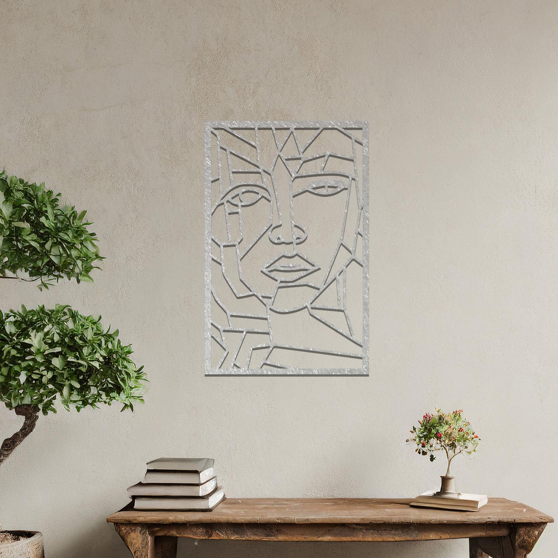 Abstract geometric face design with angular lines and sharp contours, creating a unique and modern look. The art is displayed on a neutral wall in a stylish room with contemporary furniture and vibrant flowers.