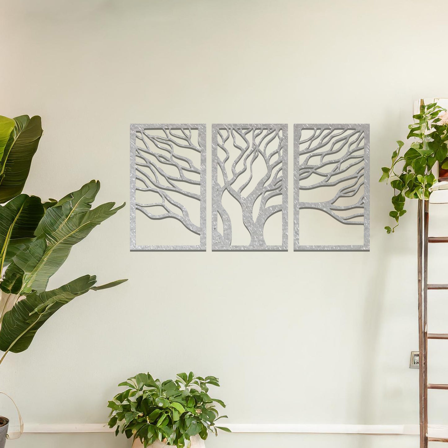 Three-panel metal wall art featuring intricately cut tree branches in a flowing design, creating a dynamic and organic effect.
