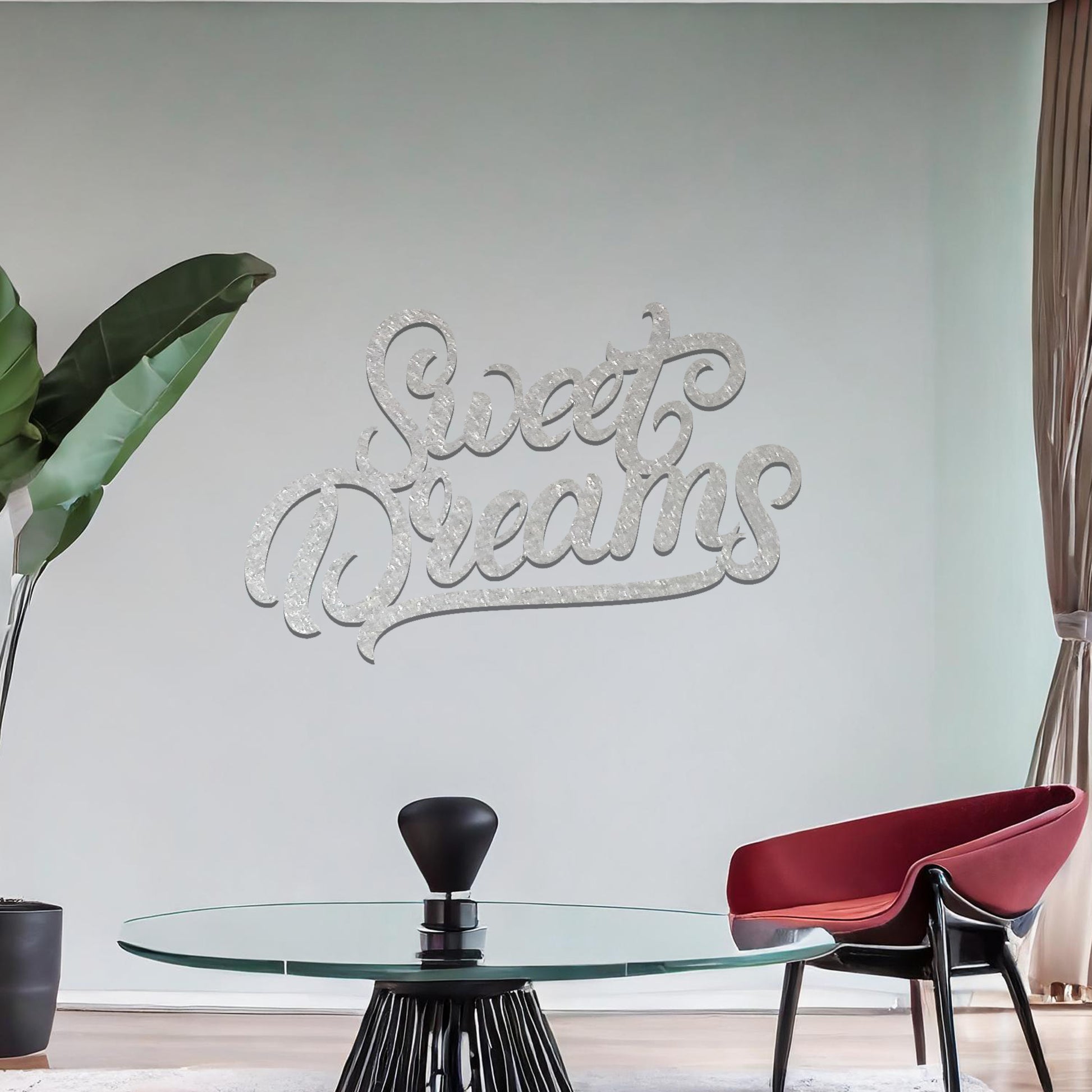 Metal wall art featuring the phrase "Sweet Dreams" in an elegant cursive font, mounted on a neutral wall within modern room decor. The artistic typography adds a charming and comforting focal point, perfect for enhancing the cosy ambiance of the space.