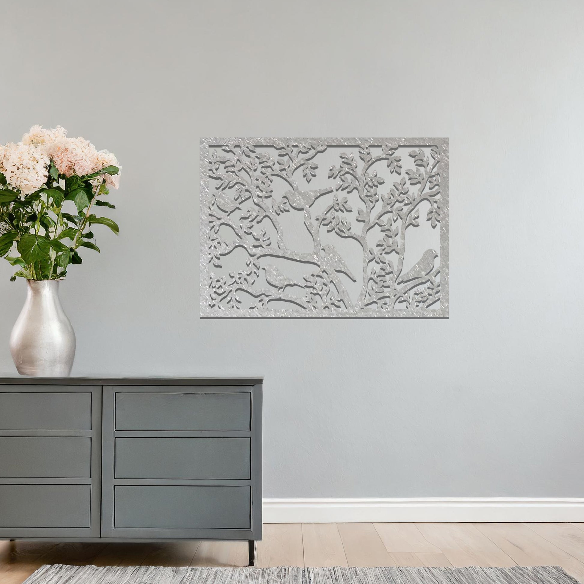 An intricately designed wall art piece showcasing birds perched on branches surrounded by delicate leaves, bringing a serene and natural touch to your interior space.