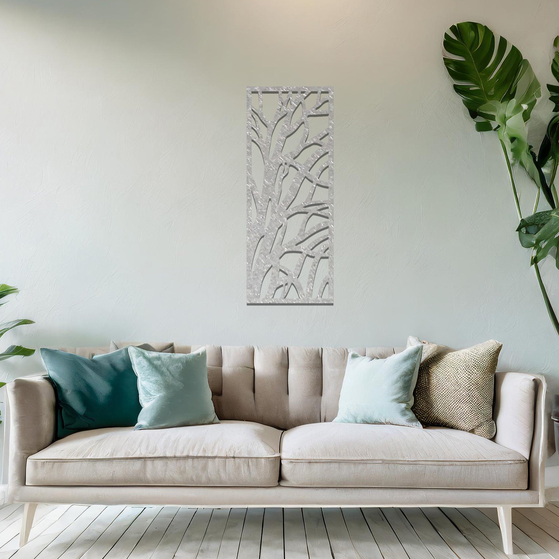 Metal wall art featuring a rectangular design with an abstract tree branch pattern, mounted on a neutral wall within modern room decor. The bold, minimalist craftsmanship adds a touch of natural elegance and contemporary style to the space.