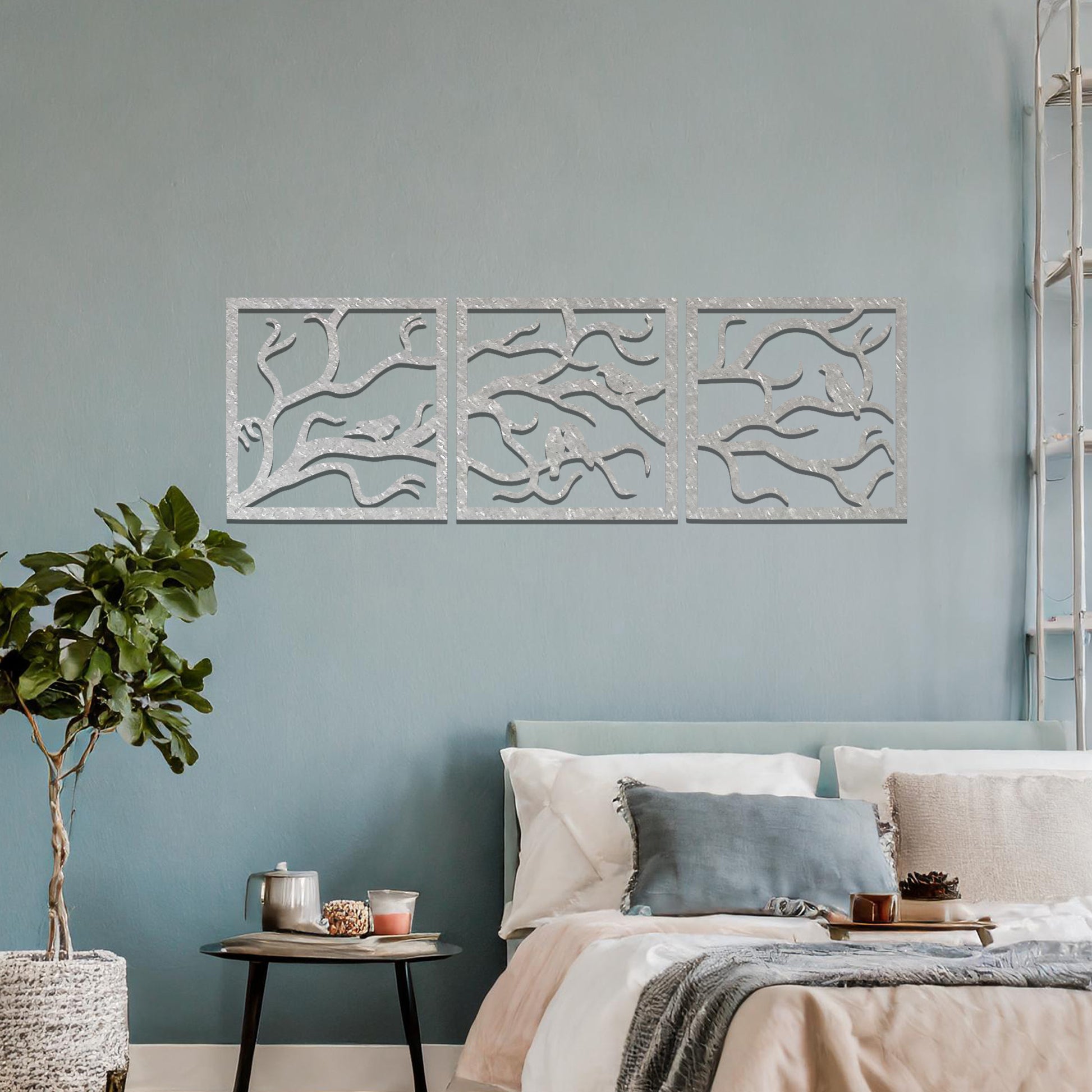 Three-panel metal wall art featuring an elegant design of birds perched on branches, creating a peaceful and nature-inspired aesthetic.