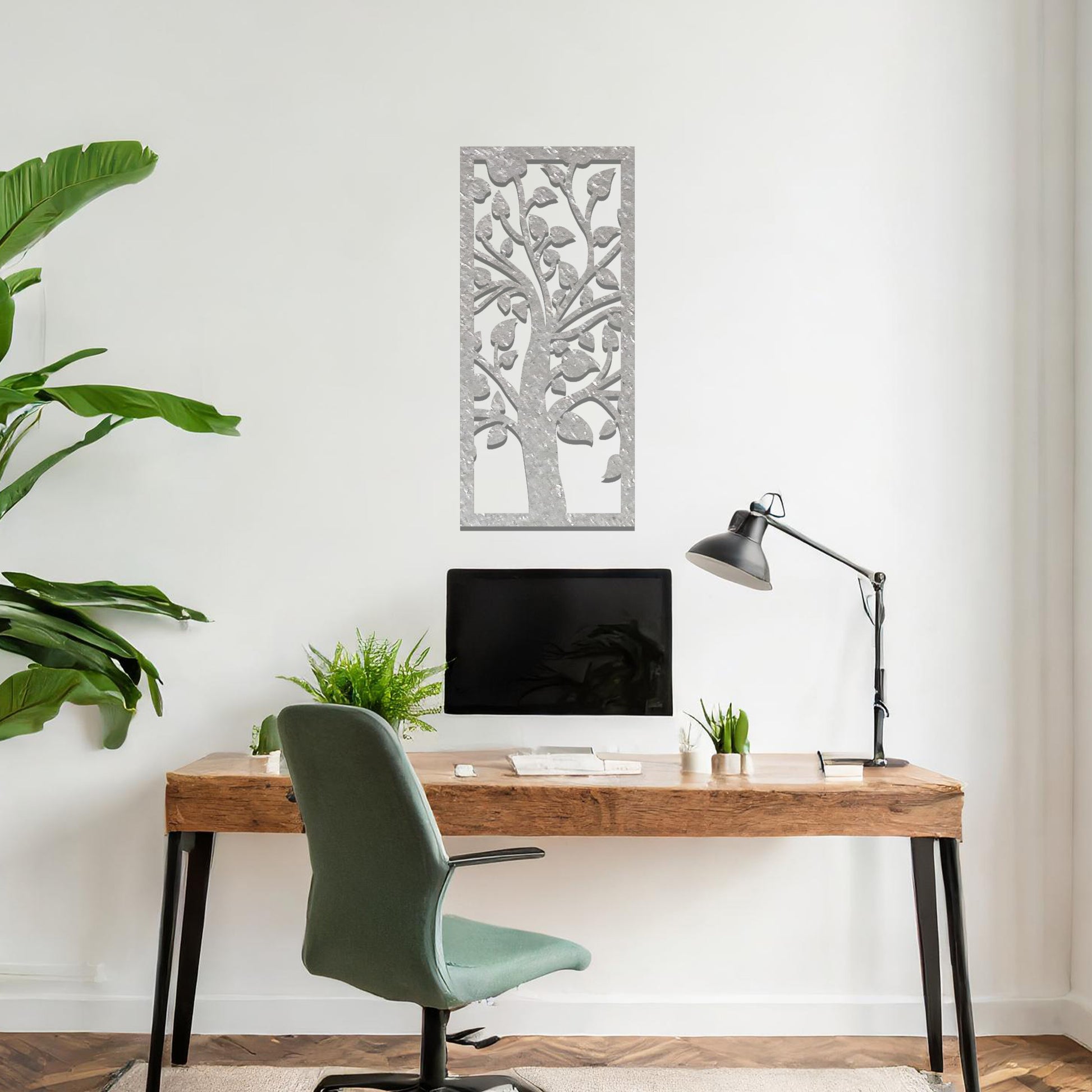 Metal wall art featuring a rectangular design with a stylised tree motif, showcasing flowing branches and leaves, mounted on a neutral wall within modern room decor. The minimalist craftsmanship adds a sleek and natural aesthetic, enhancing the contemporary elegance of the space.
