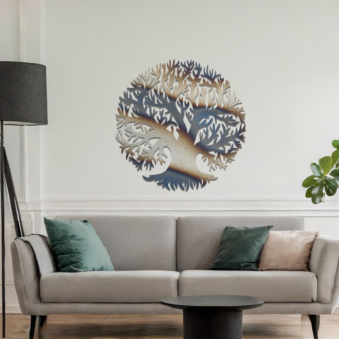 Metal wall art featuring a circular tree design with intricate branches and roots, crafted with precise laser-cut detailing, placed on a neutral wall within modern decor.