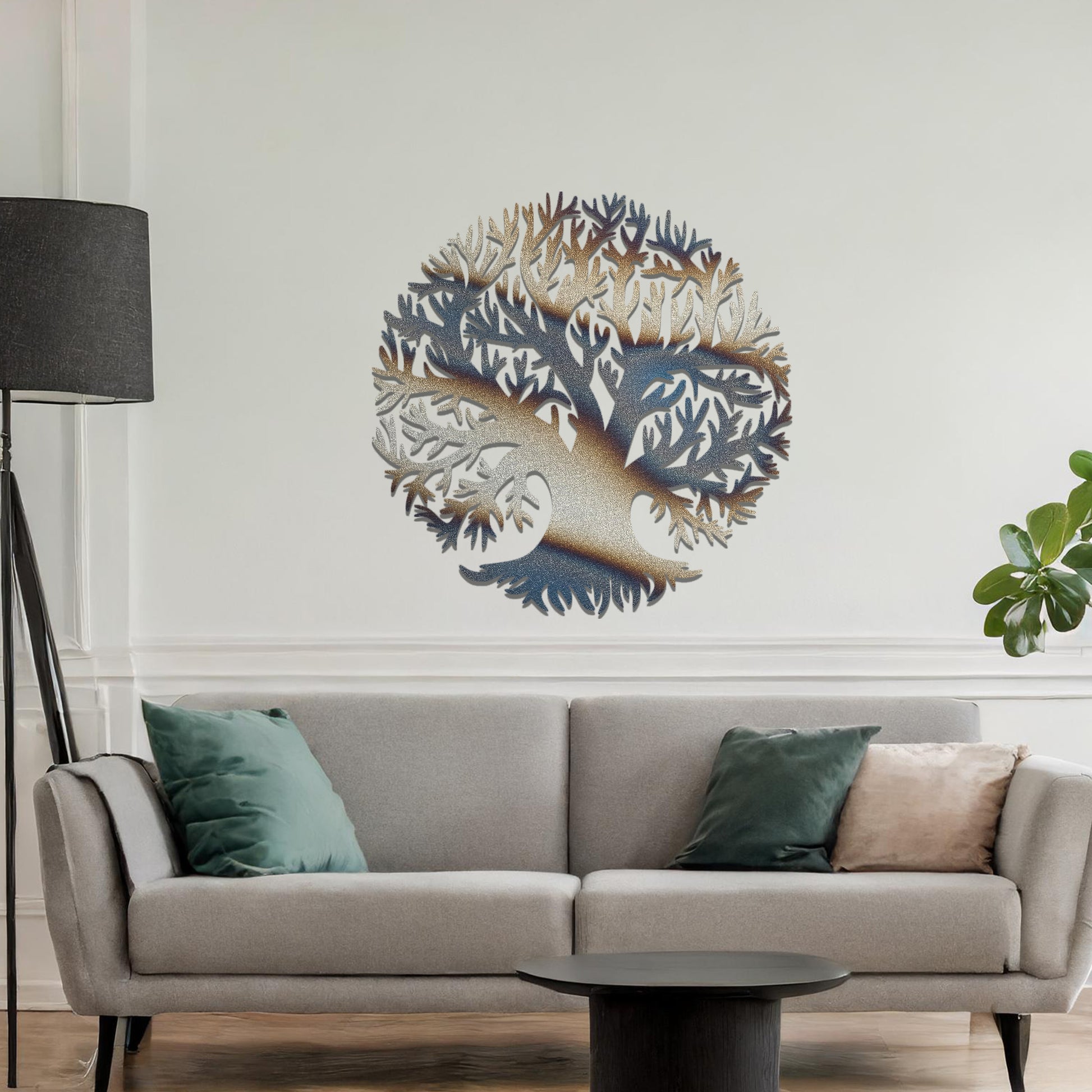 Metal wall art featuring a circular tree design with intricate branches and roots, crafted with precise laser-cut detailing, placed on a neutral wall within modern decor.