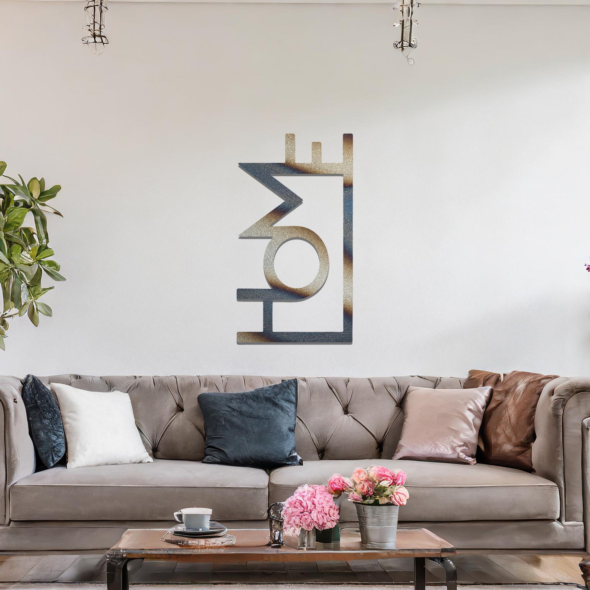 A modern metal wall art design featuring the word "HOME" in bold, geometric typography with an innovative, angular twist. The artwork is displayed on a neutral wall in a contemporary room setting.
