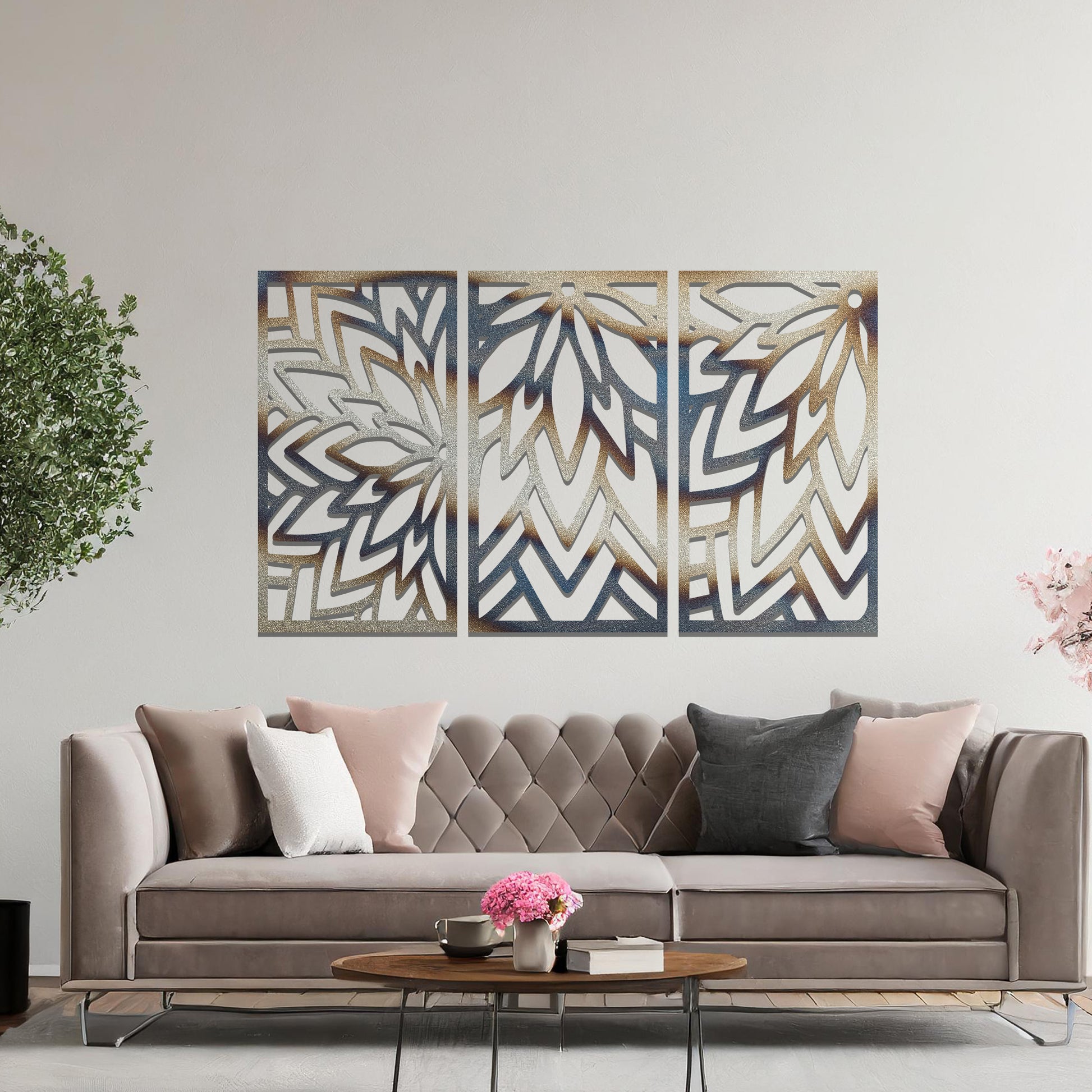 Metal wall art featuring a three-panel design with floral-inspired geometric patterns, crafted with precise laser-cut detailing, displayed on a neutral wall within modern decor.