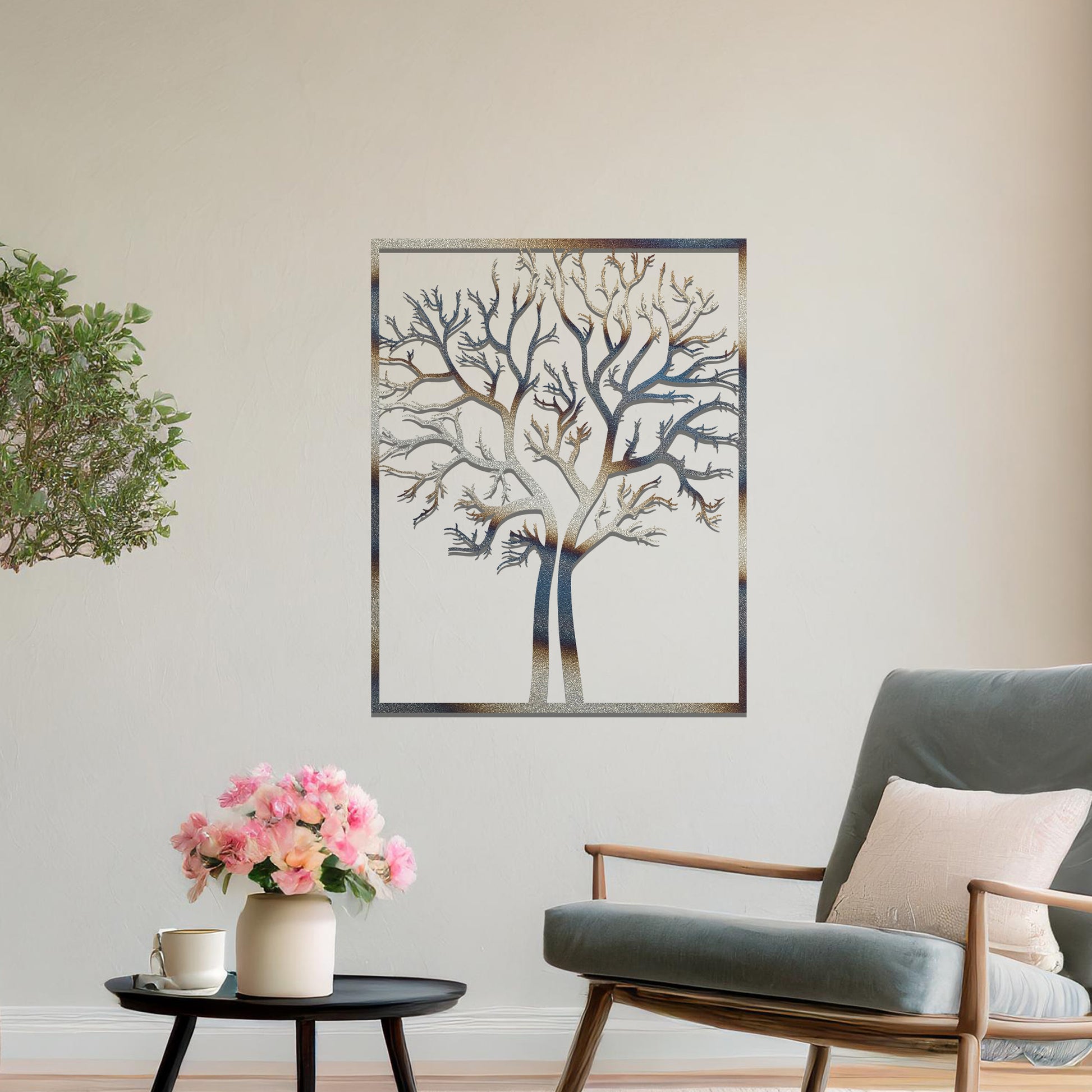 Metal wall art featuring a framed tree design with intricate, bare branches, crafted with precise laser-cut techniques, displayed on a neutral wall within modern decor.