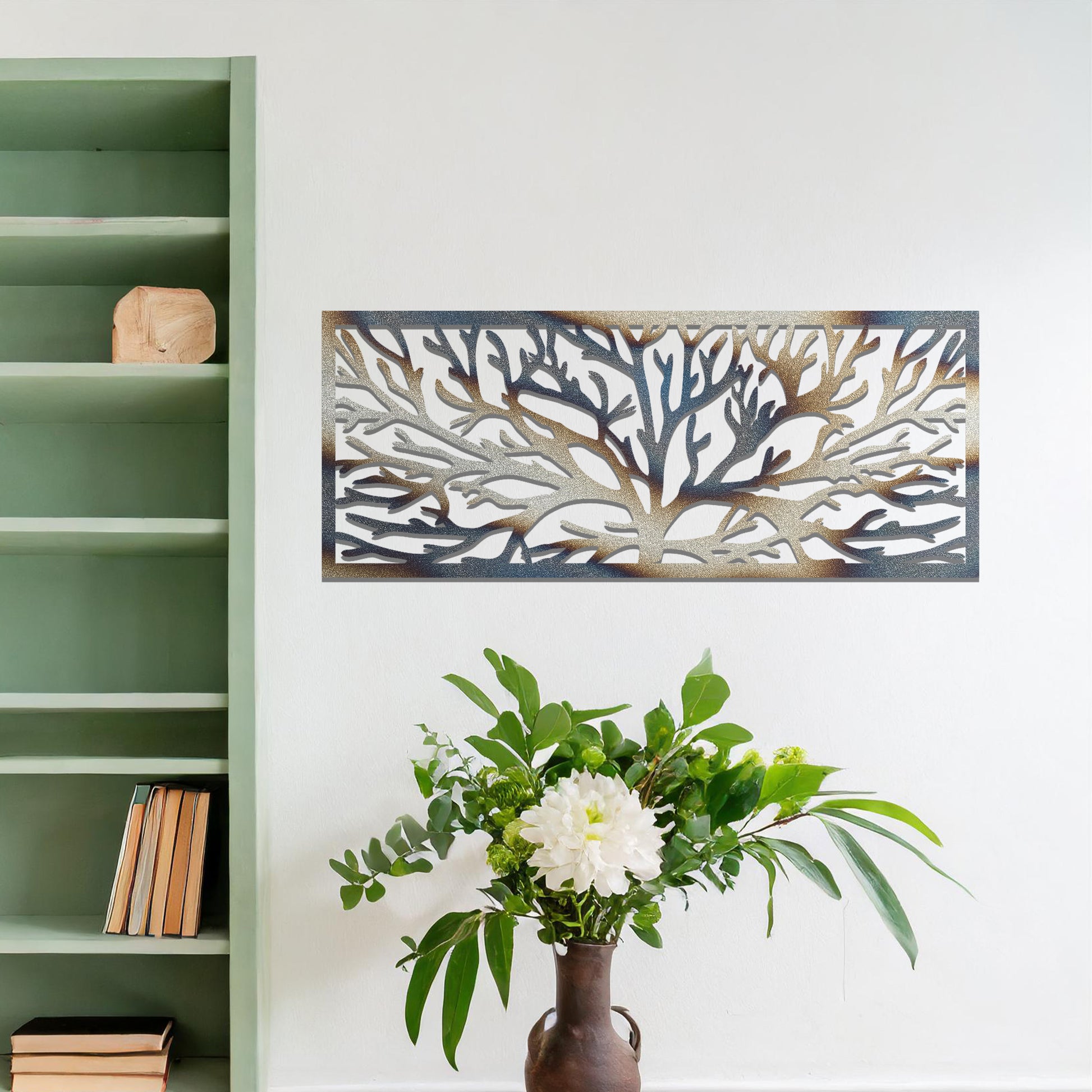 A metal wall art design featuring a detailed tree silhouette with sprawling branches, enclosed in a rectangular frame. The art is displayed on a neutral wall in a modern living room, complementing the contemporary decor and natural elements in the space.